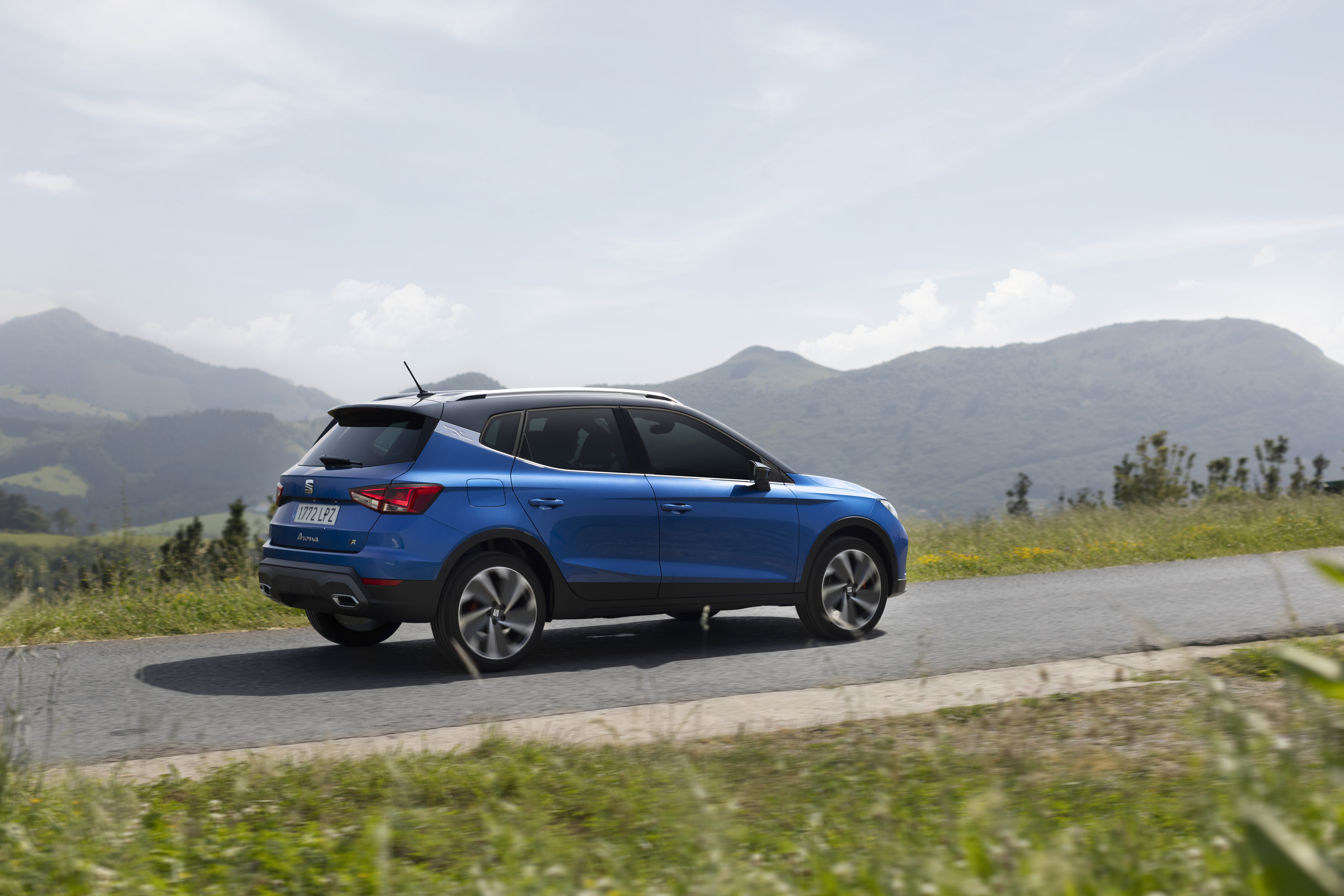 Blue 2021 SEAT Arona FR SUV driving on a road HD Wallpaper
