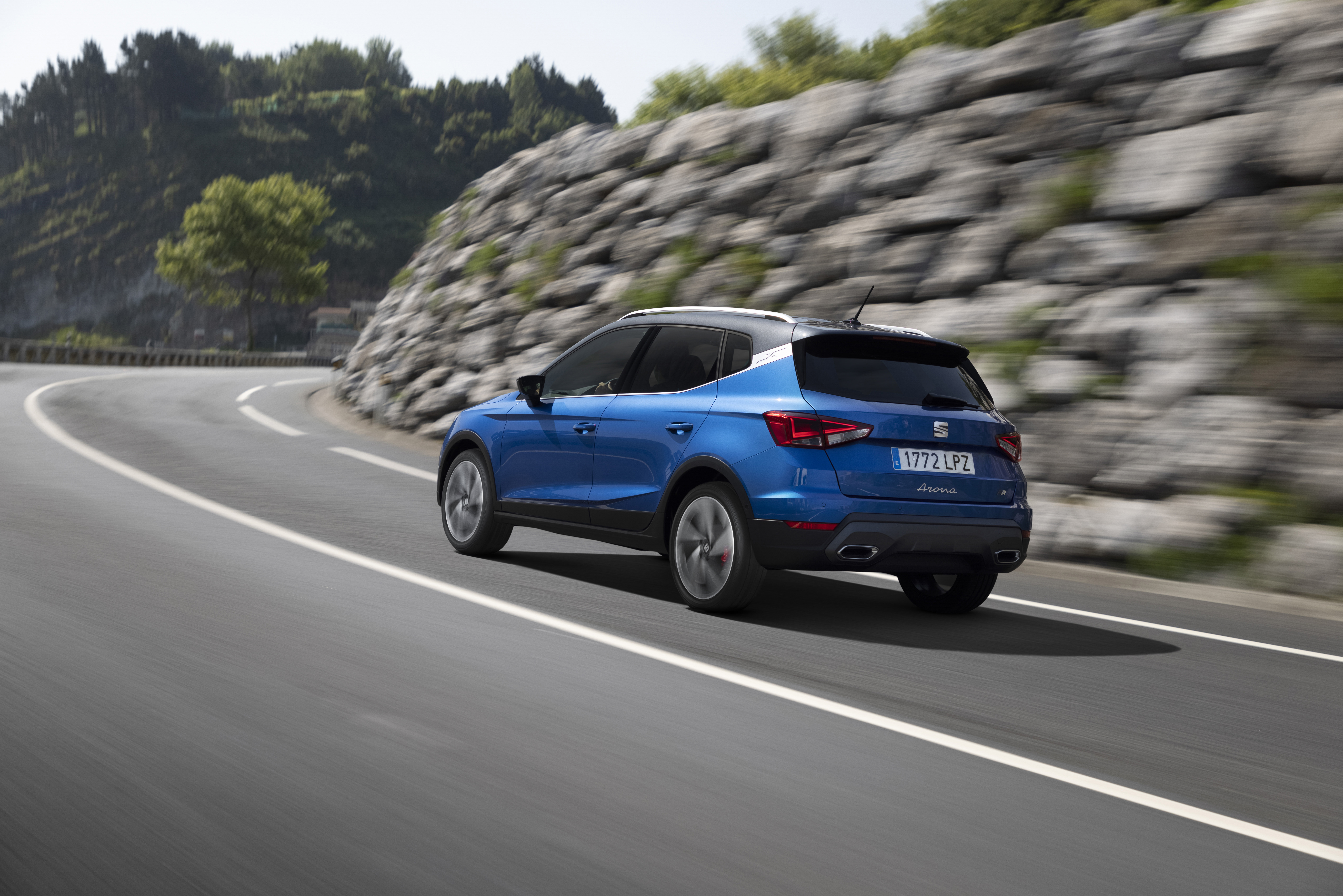 Blue 2021 SEAT Arona FR driving on a winding road HD Wallpaper