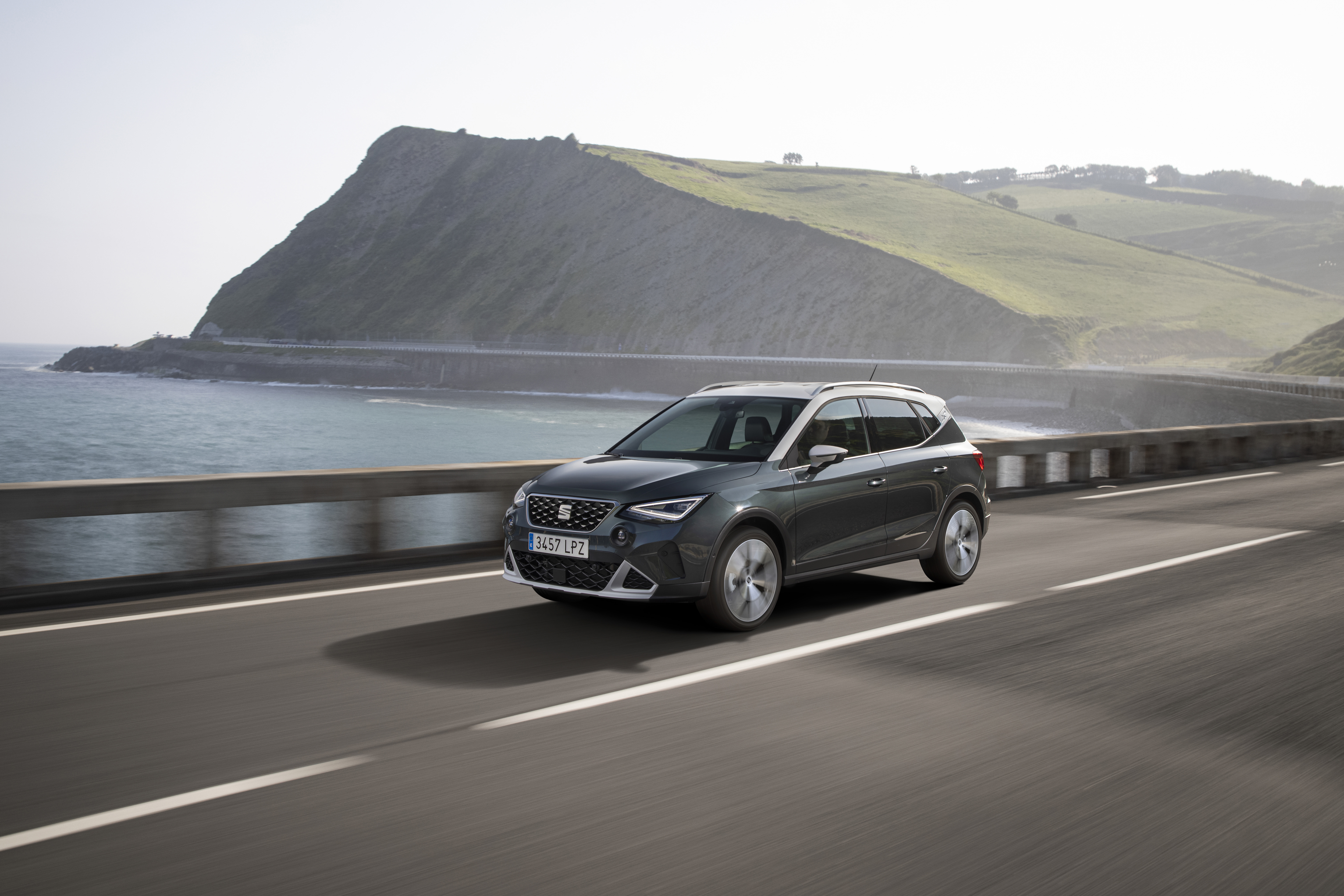 2021 SEAT Arona Xperience driving on coastal road HD Wallpaper