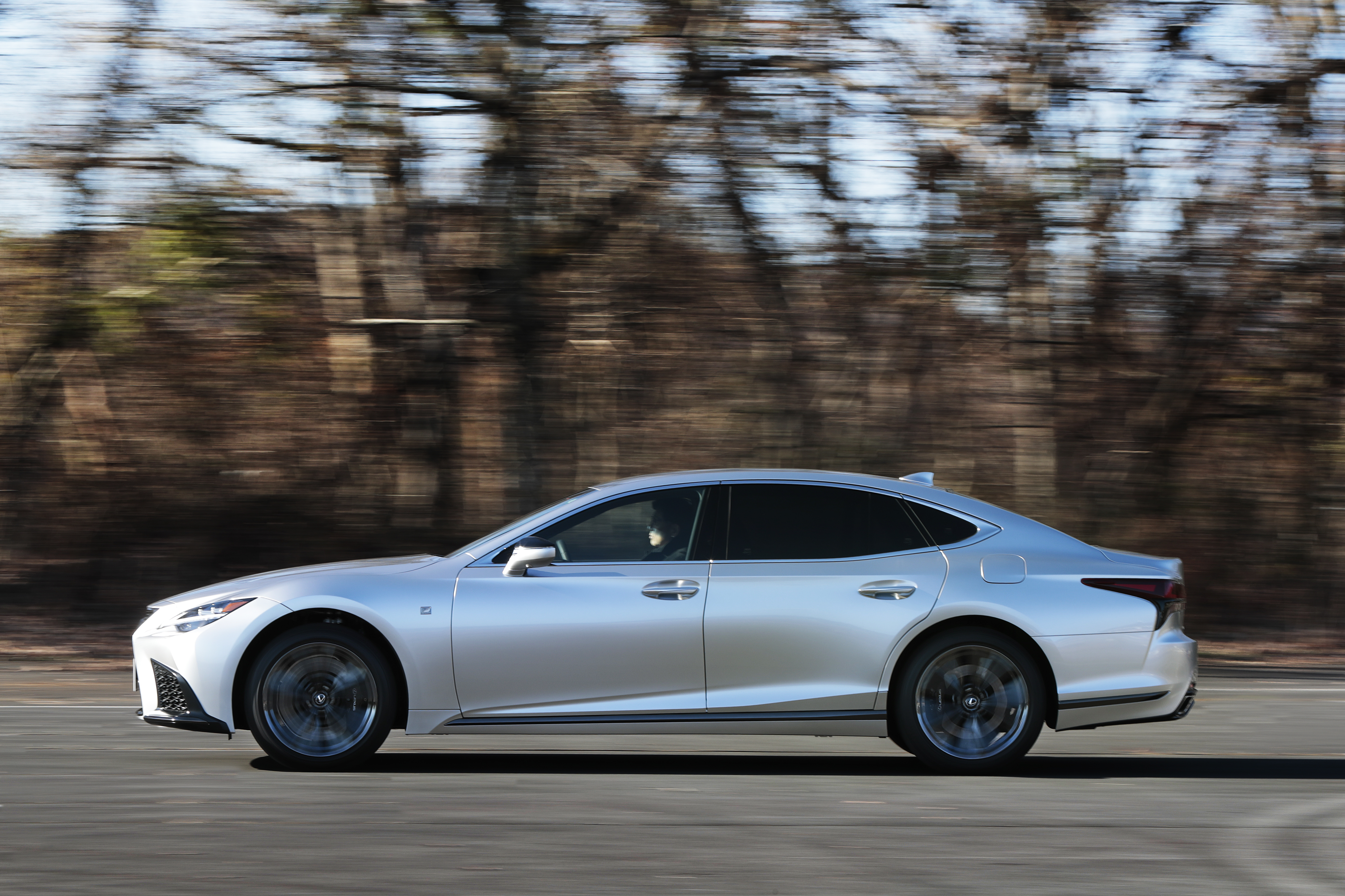 Silver Lexus LS 500 F SPORT driving on a road HD Wallpaper