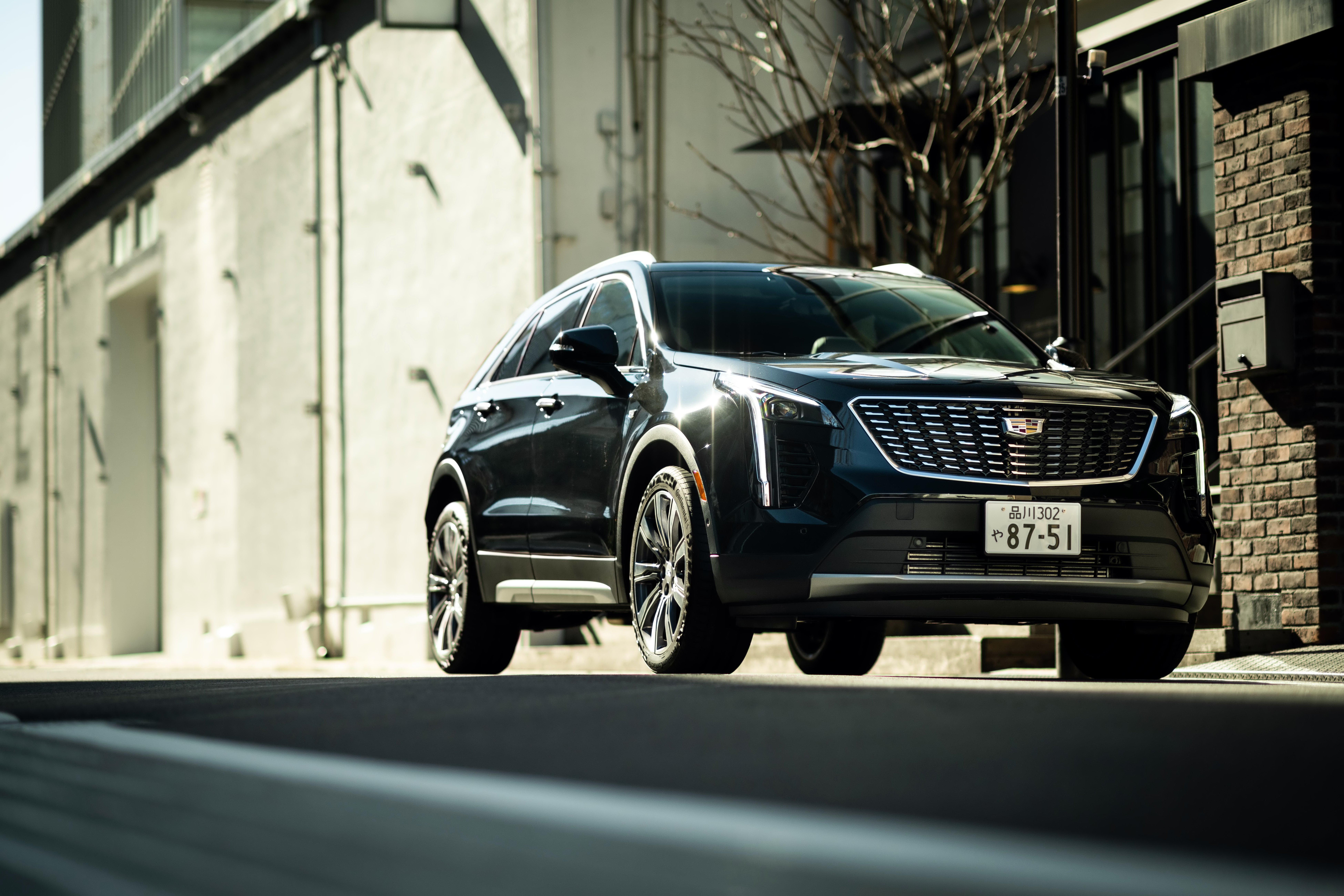 Black Cadillac XT4 350T Sport SUV on street HD Wallpaper