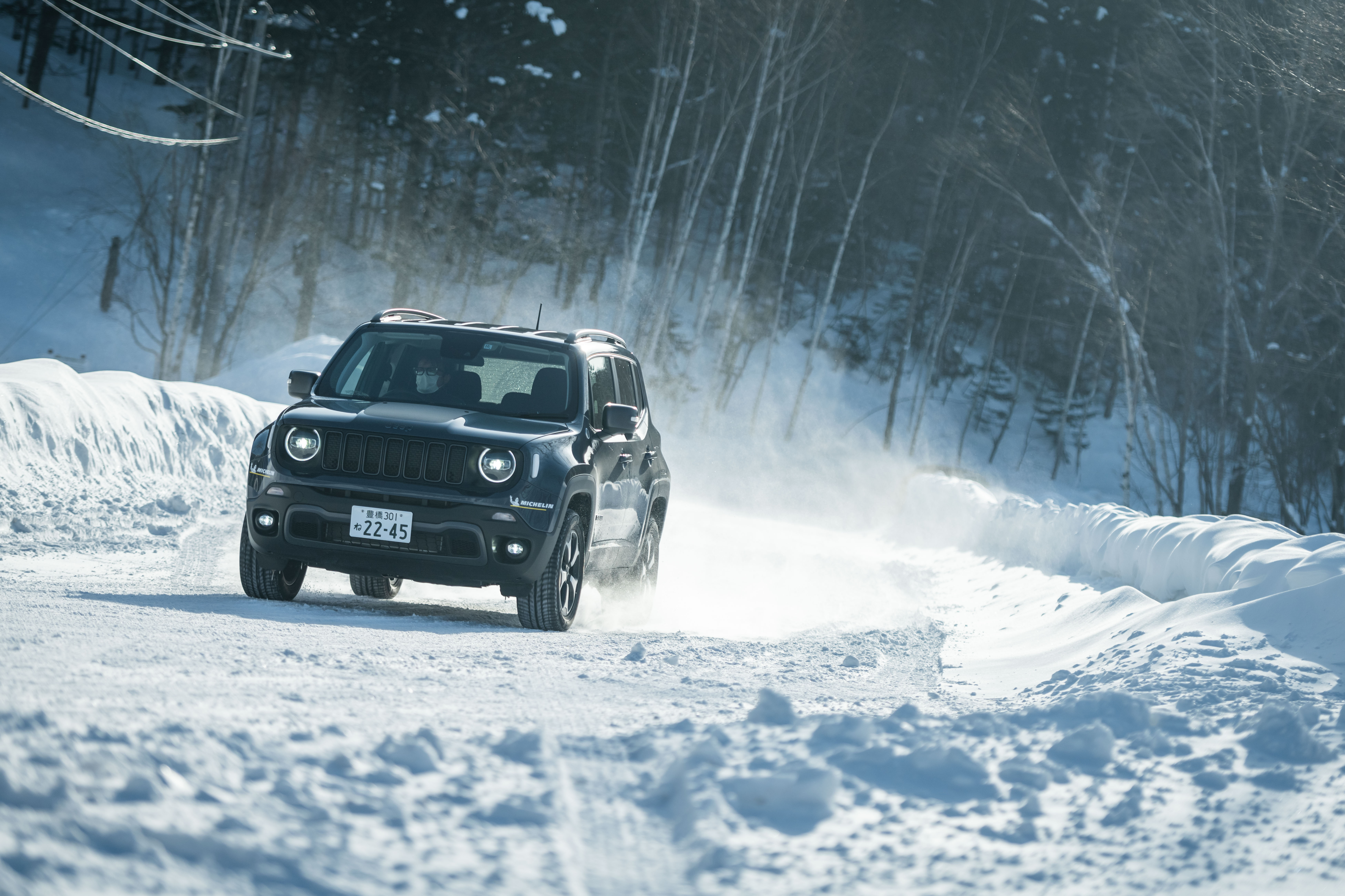 Jeep Renegade Trailhawk 4xe driving on snowy road HD Wallpaper