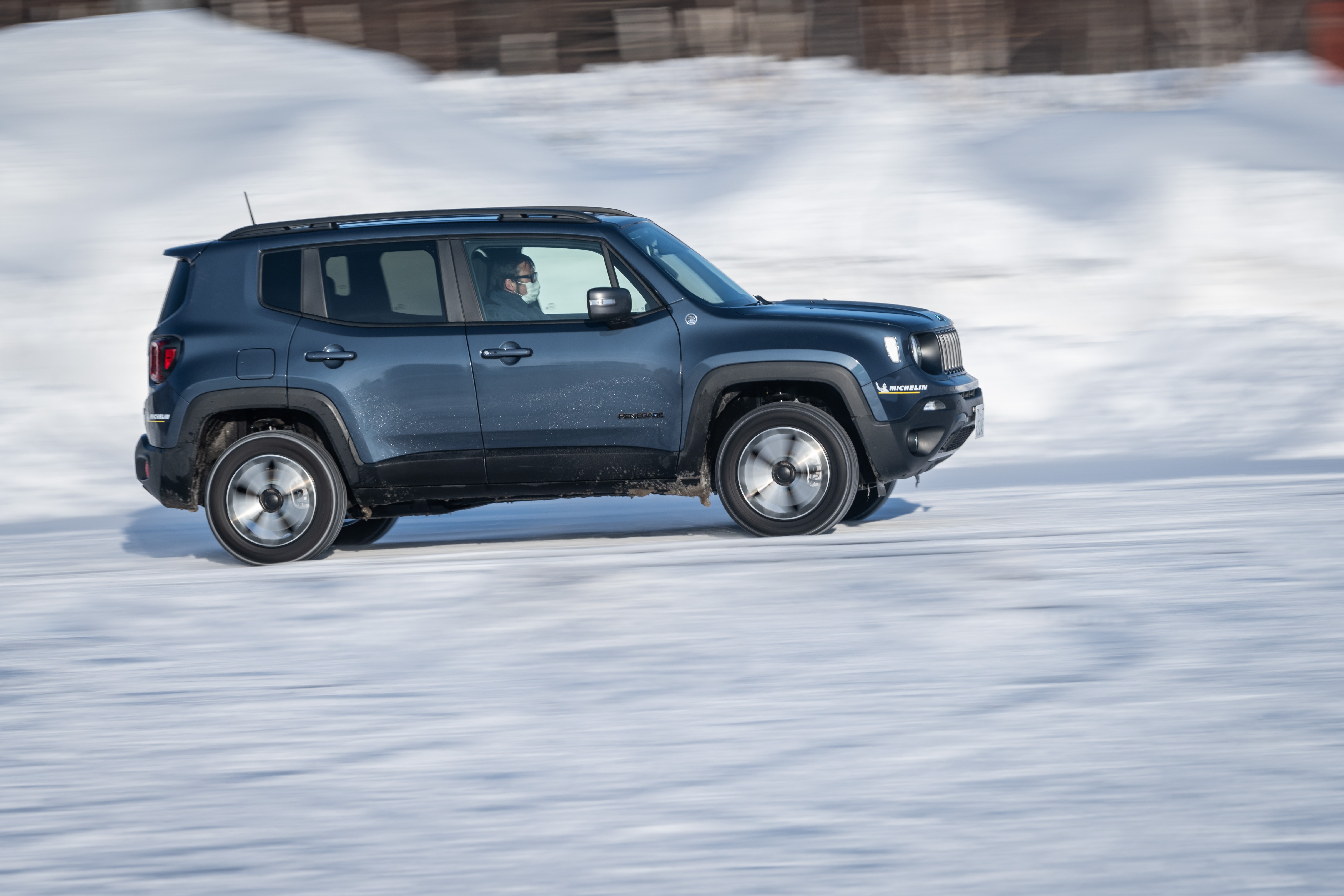 Jeep Renegade Trailhawk 4xe driving on snow HD Wallpaper