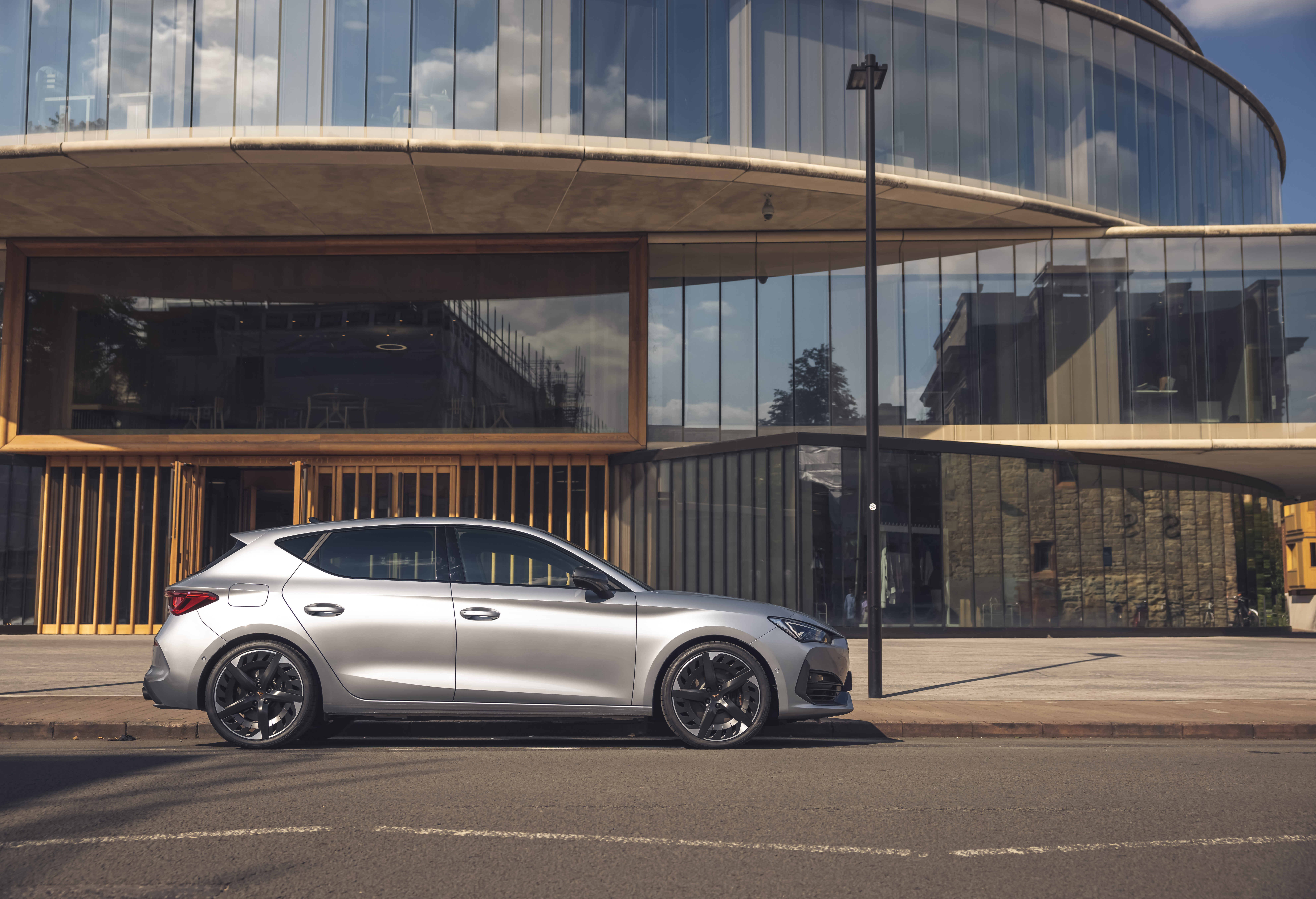 Silver 2021 Cupra León VZ3 parked by modern building HD Wallpaper