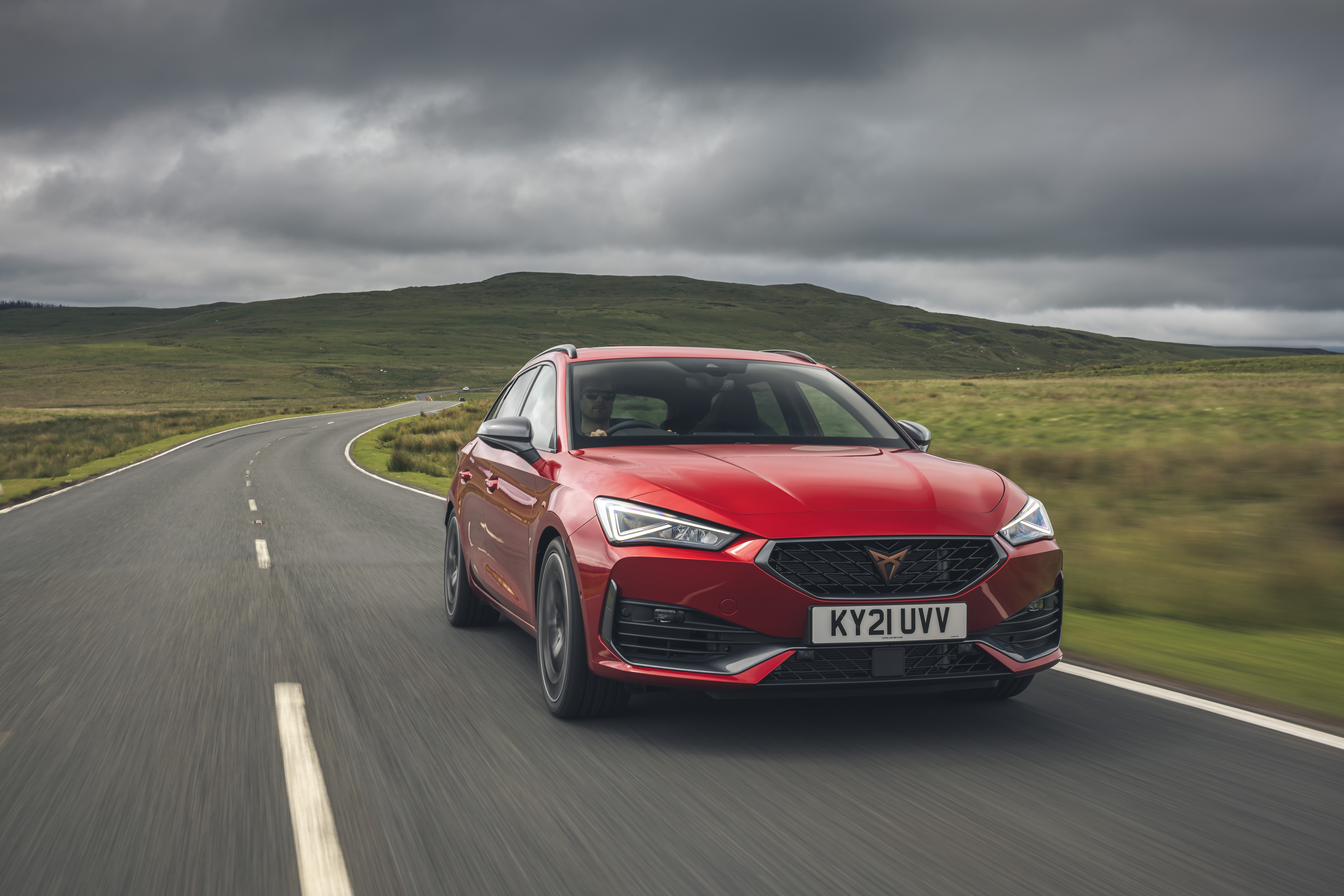 Red 2021 Cupra Leon Estate driving on a country road HD Wallpaper