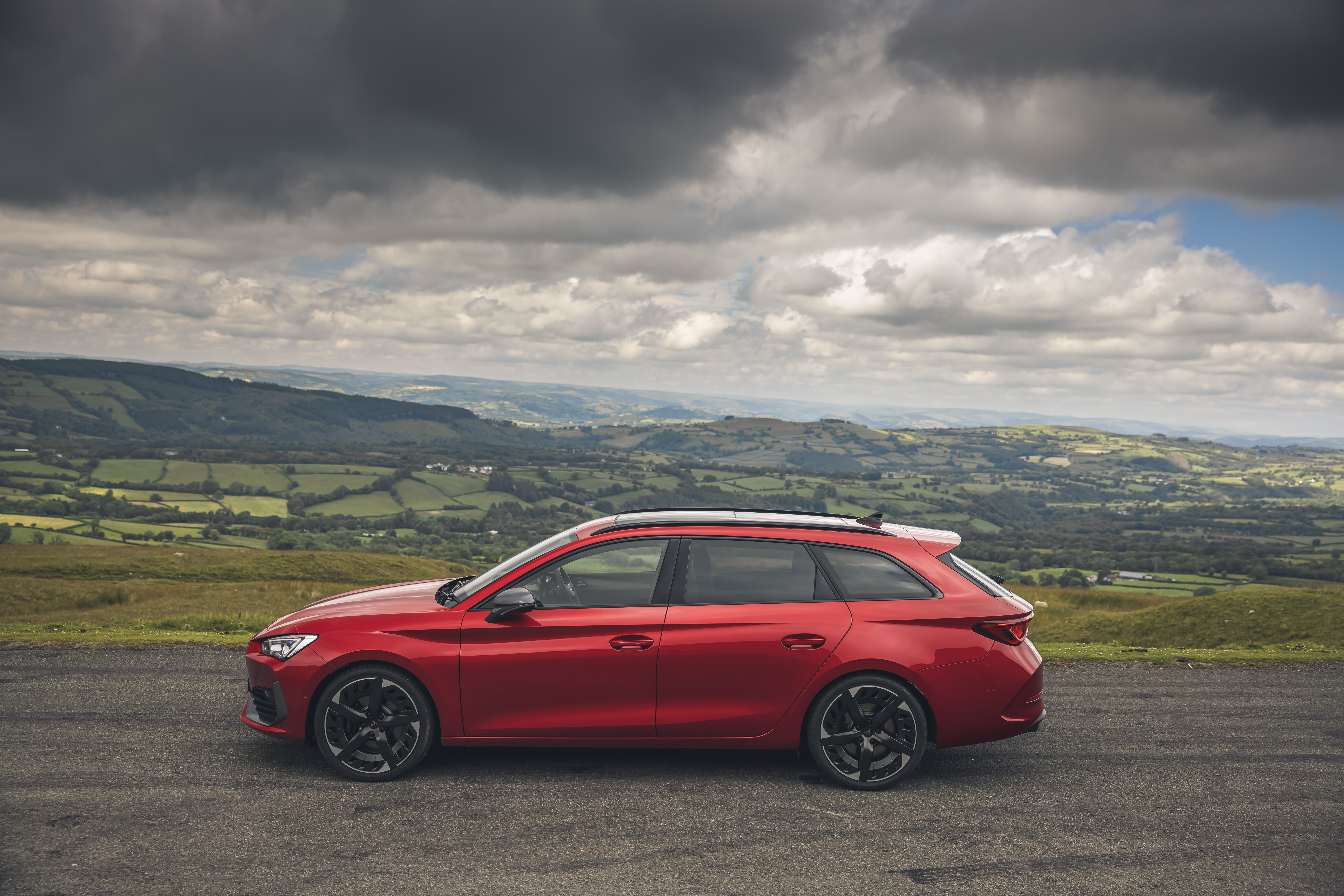 Red Cupra Leon Estate parked on a hill HD Wallpaper