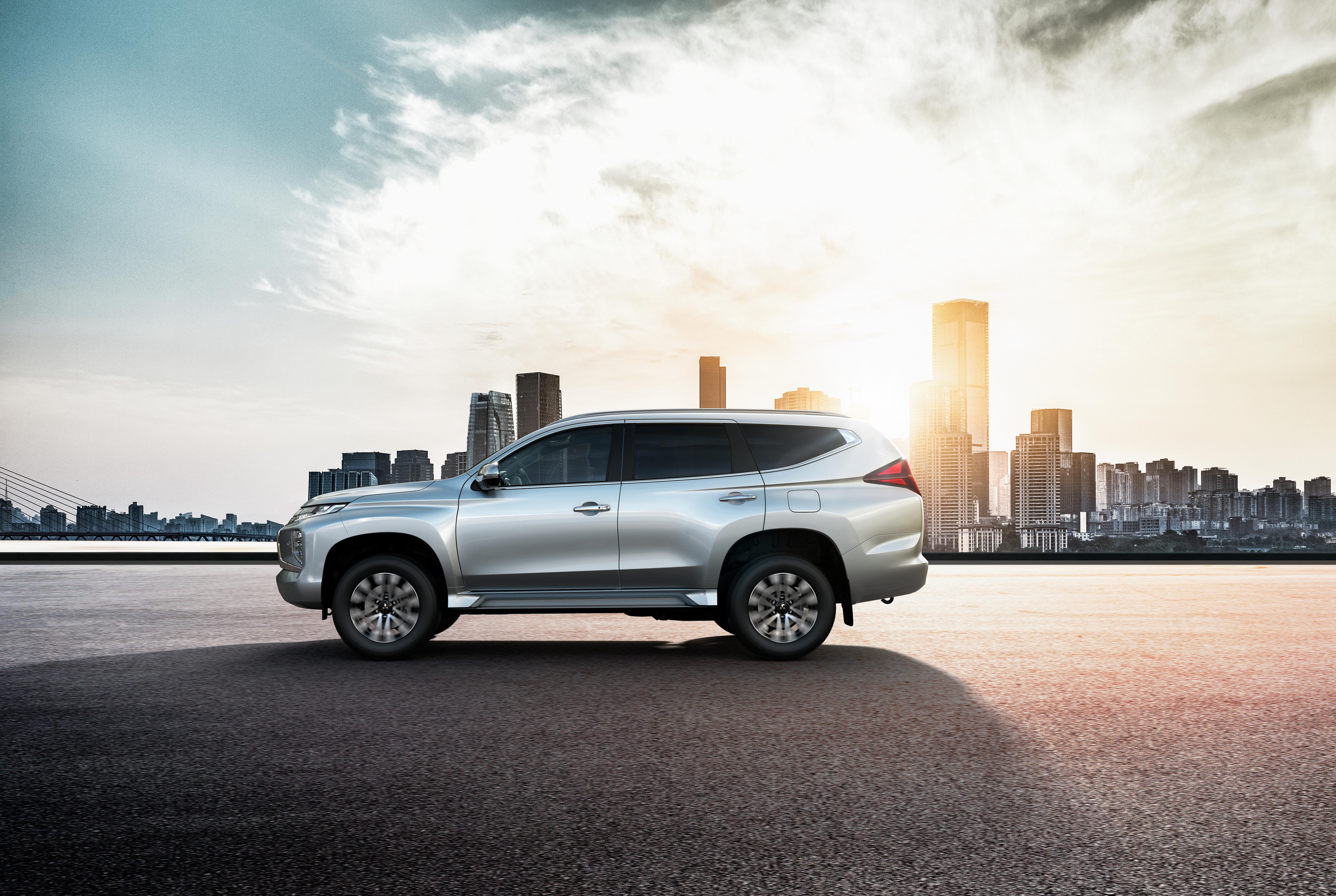 2021 Mitsubishi Pajero Sport SUV in city skyline HD Wallpaper