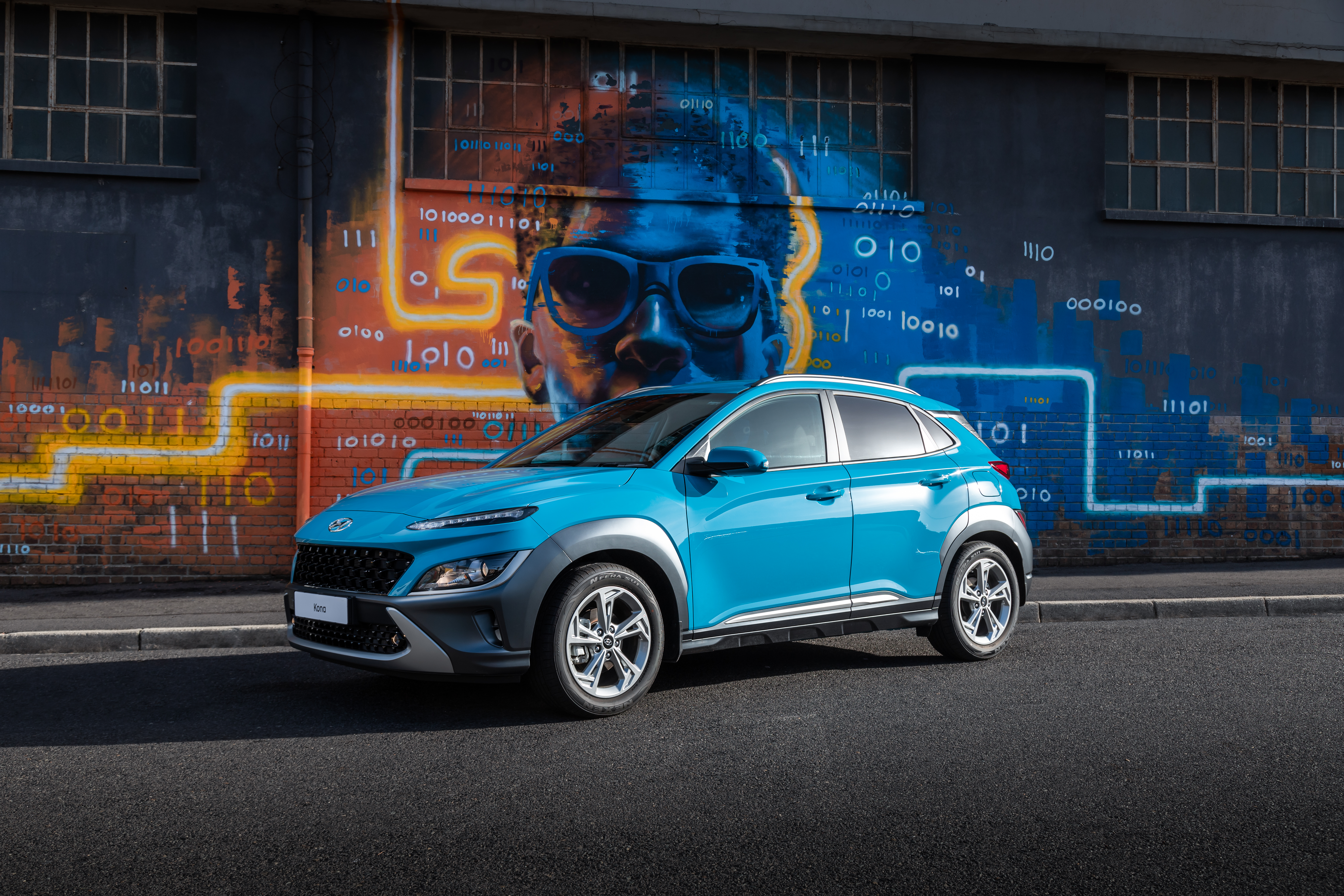 Blue 2021 Hyundai Kona SUV parked in front of graffiti HD Wallpaper