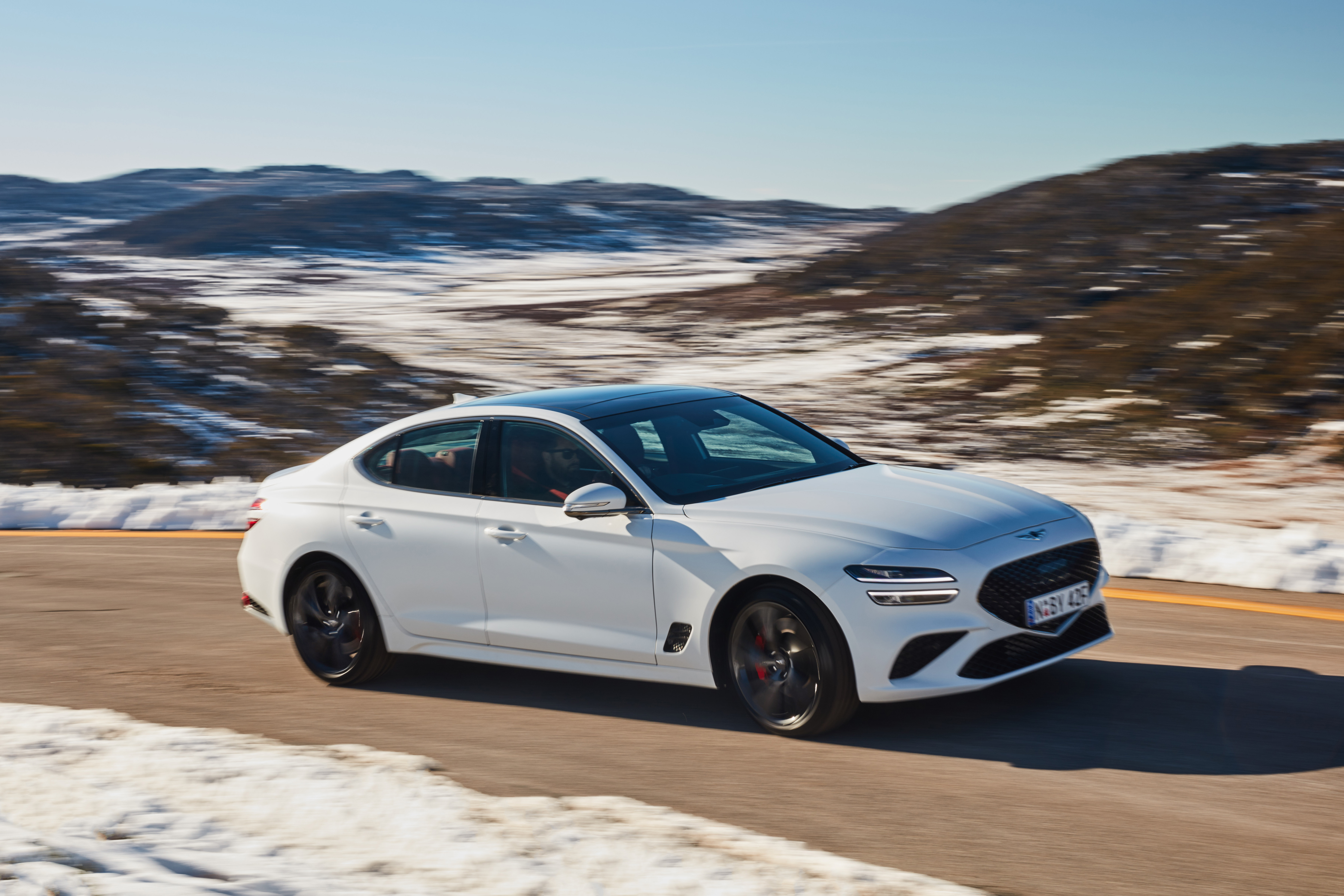 White 2021 Genesis G70 3.3T Sport on Snowy Road HD Wallpaper