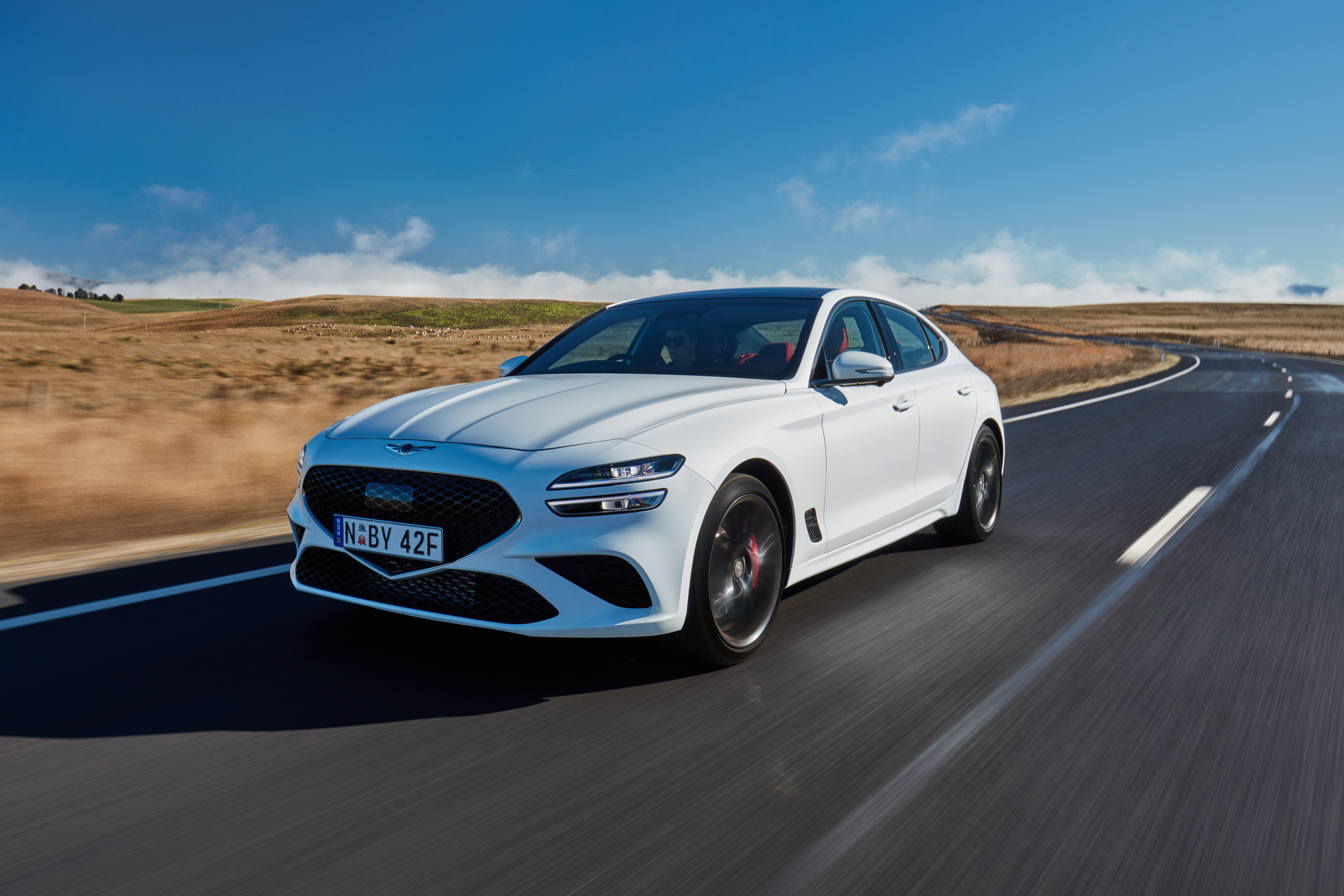 White 2021 Genesis G70 3.3T Sport on a winding road HD Wallpaper