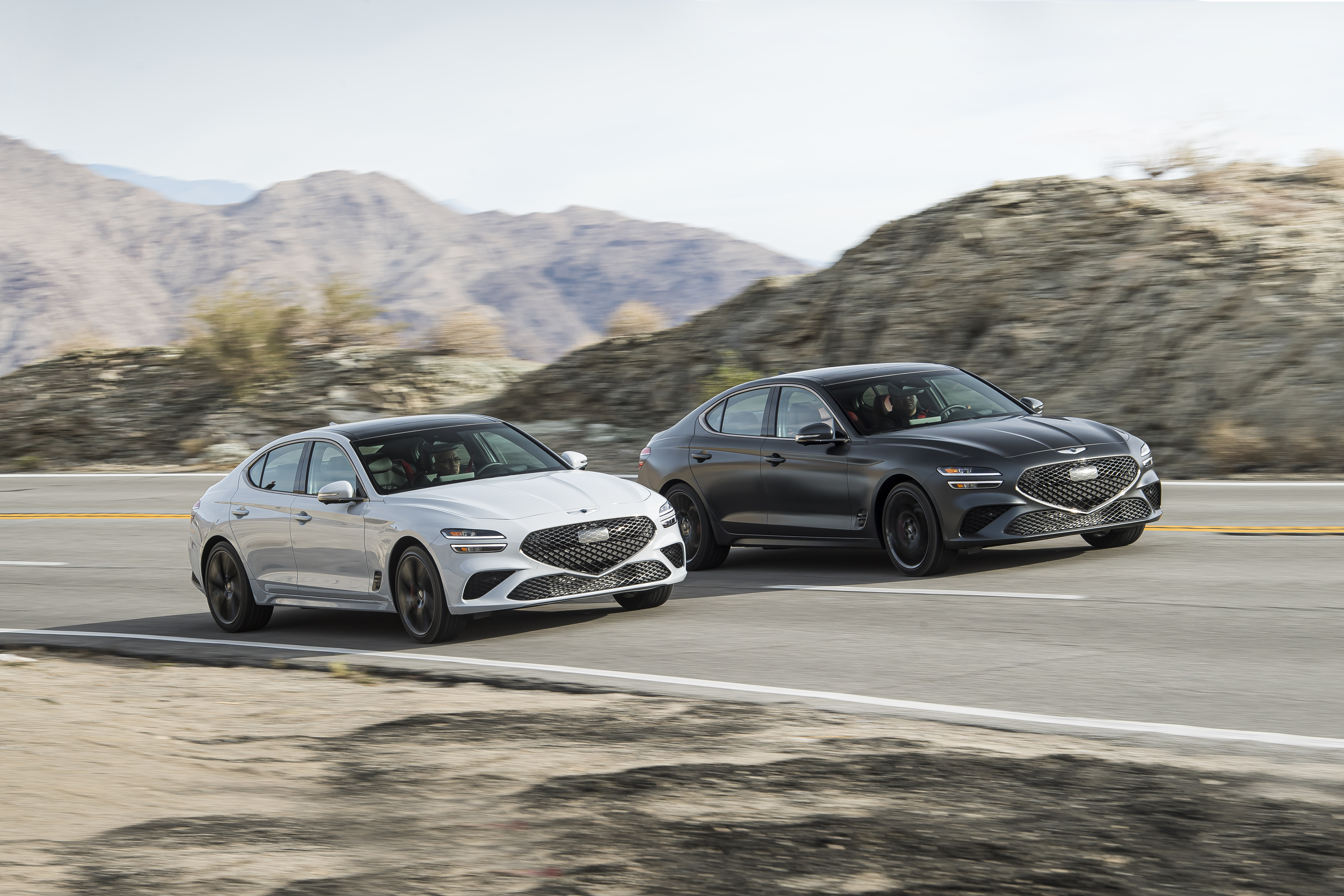 Genesis G70 3.3T AWD luxury cars on a desert road HD Wallpaper