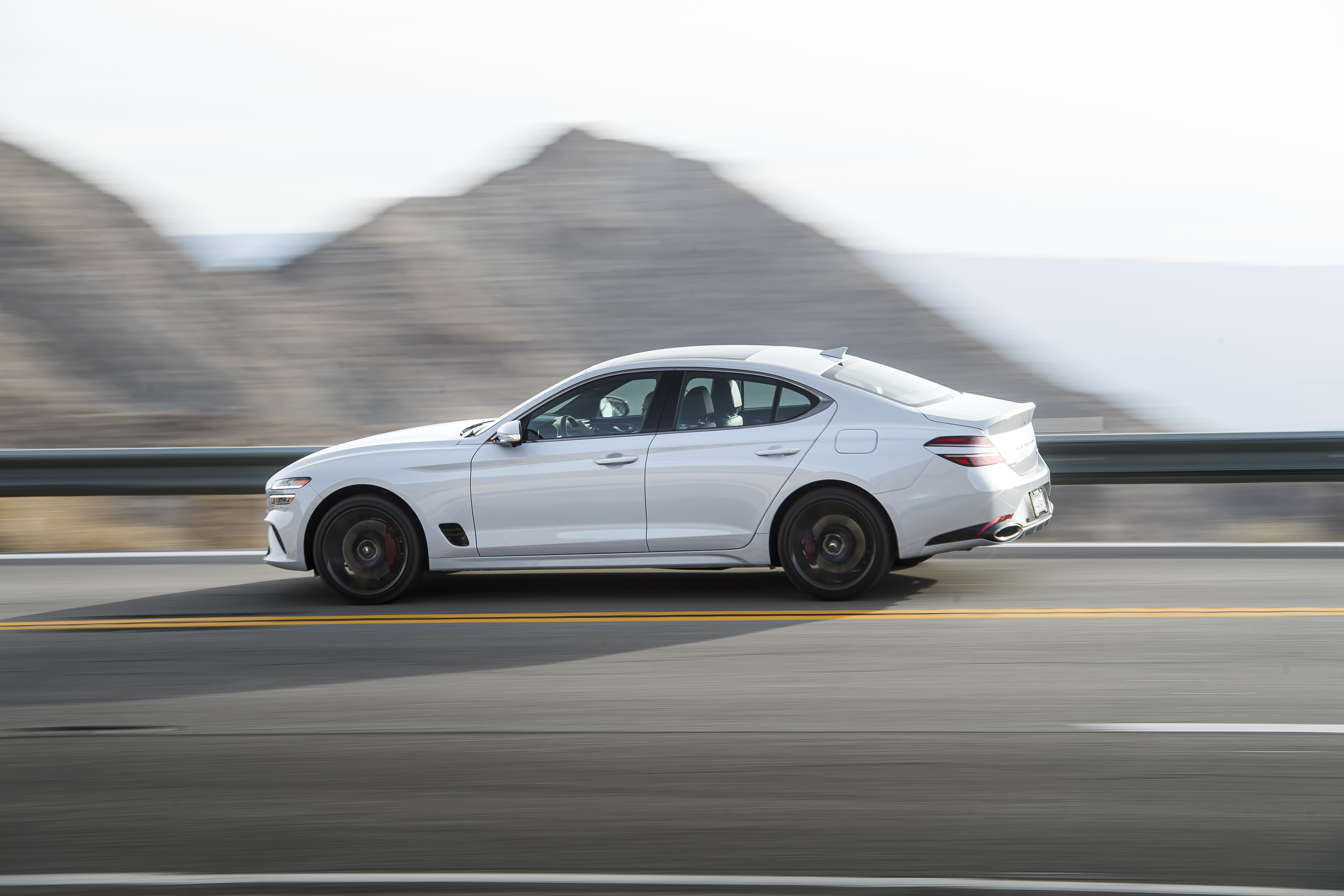 White 2022 Genesis G70 3.3T AWD driving on highway HD Wallpaper