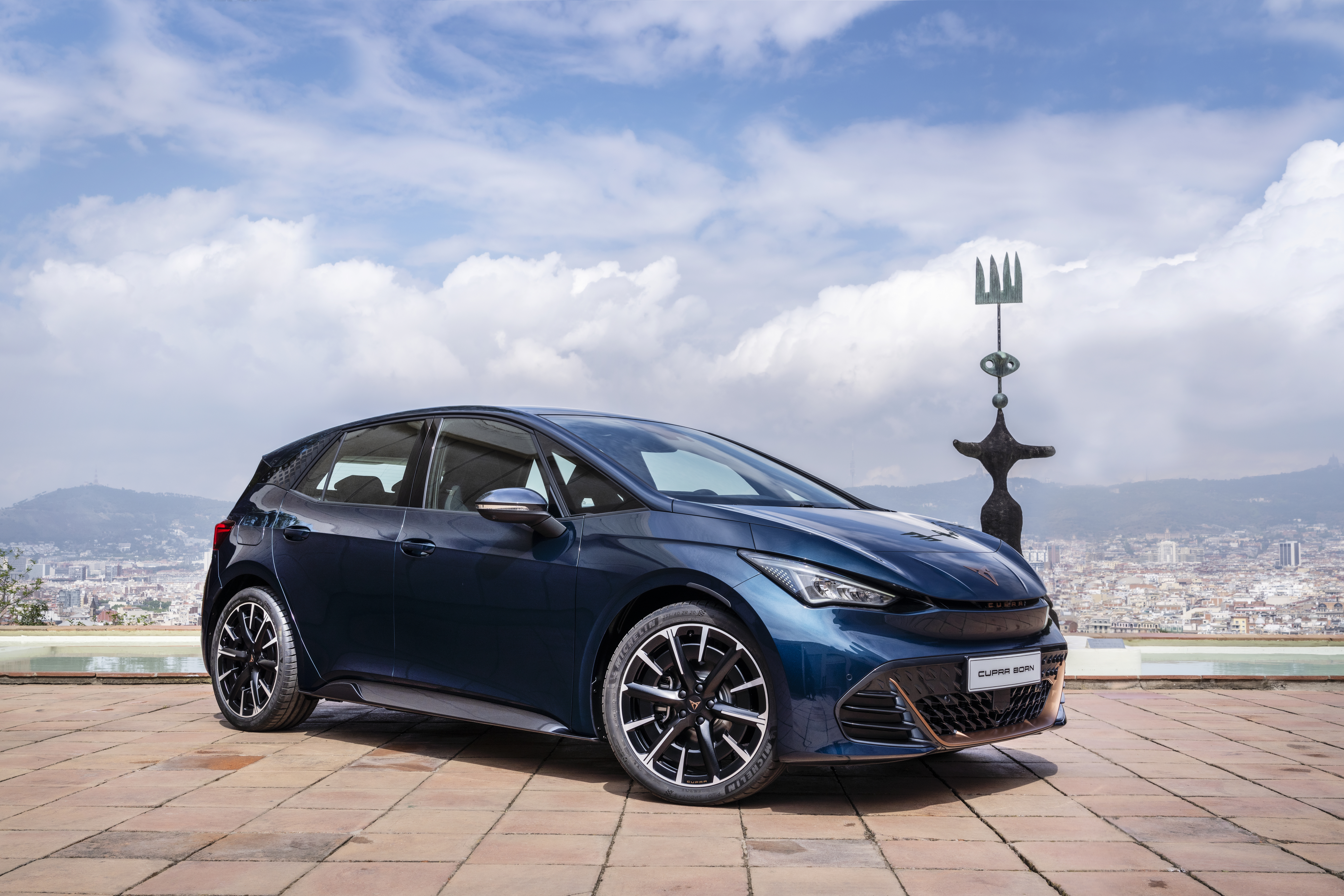 Blue 2021 Cupra Born electric car with city background HD Wallpaper