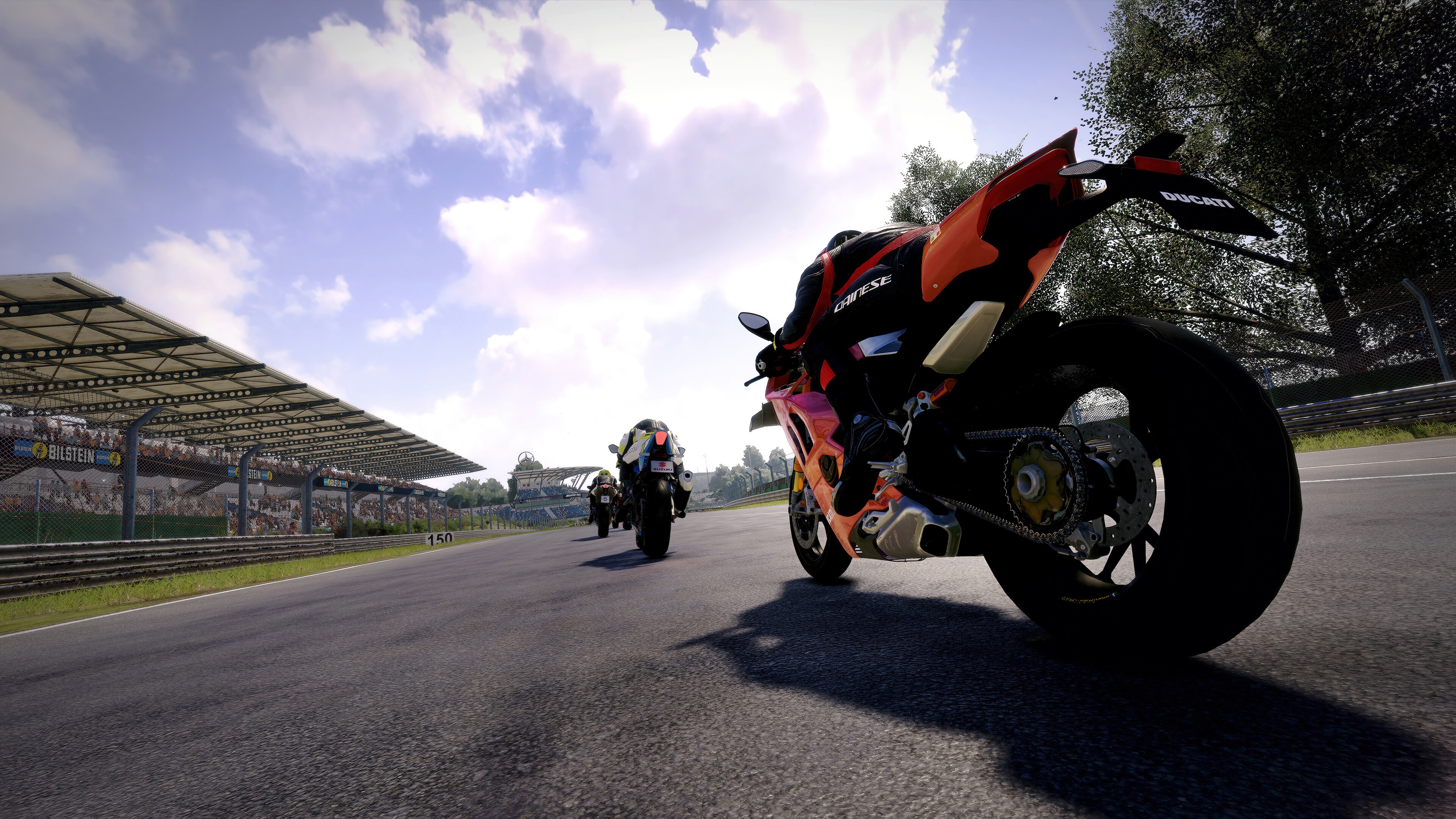 Motorcycle racing on a track with grandstands HD Wallpaper