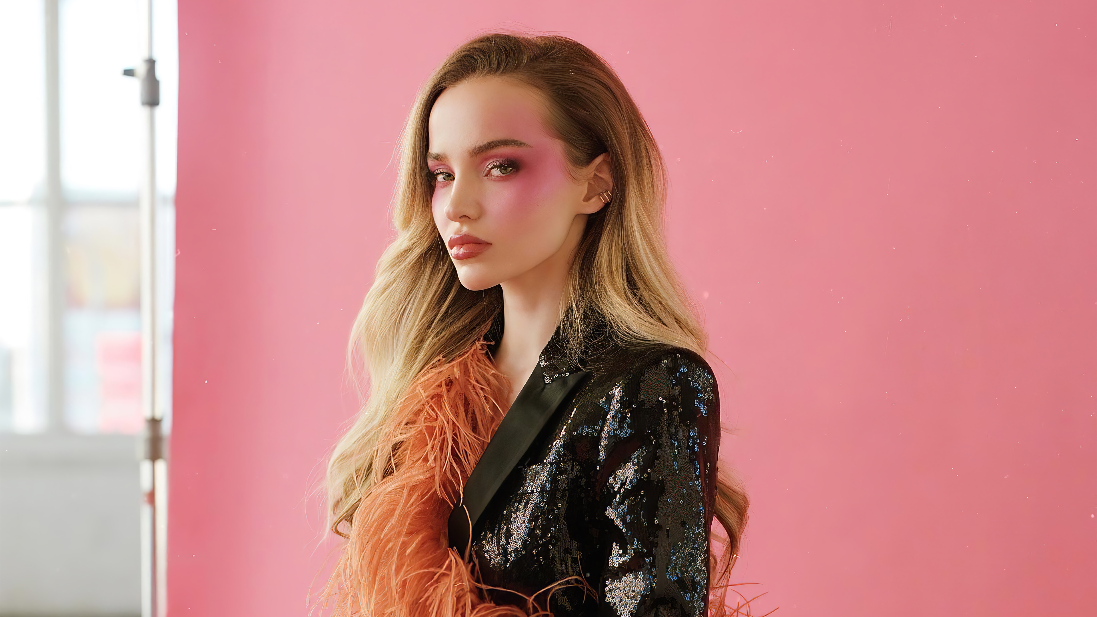 Dove Cameron in a sequined jacket with orange feathers HD Wallpaper