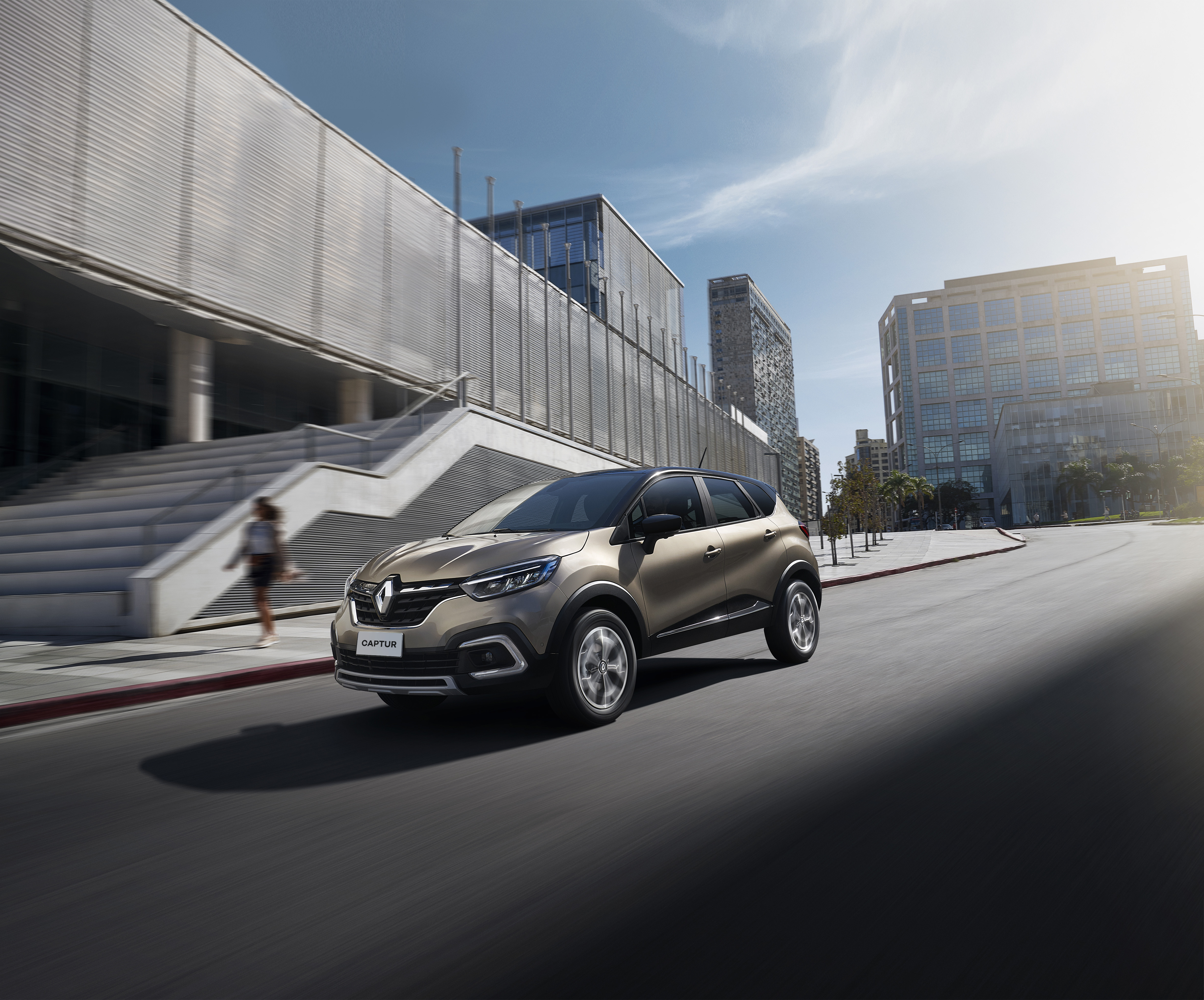 Renault Captur SUV driving on a city street HD Wallpaper