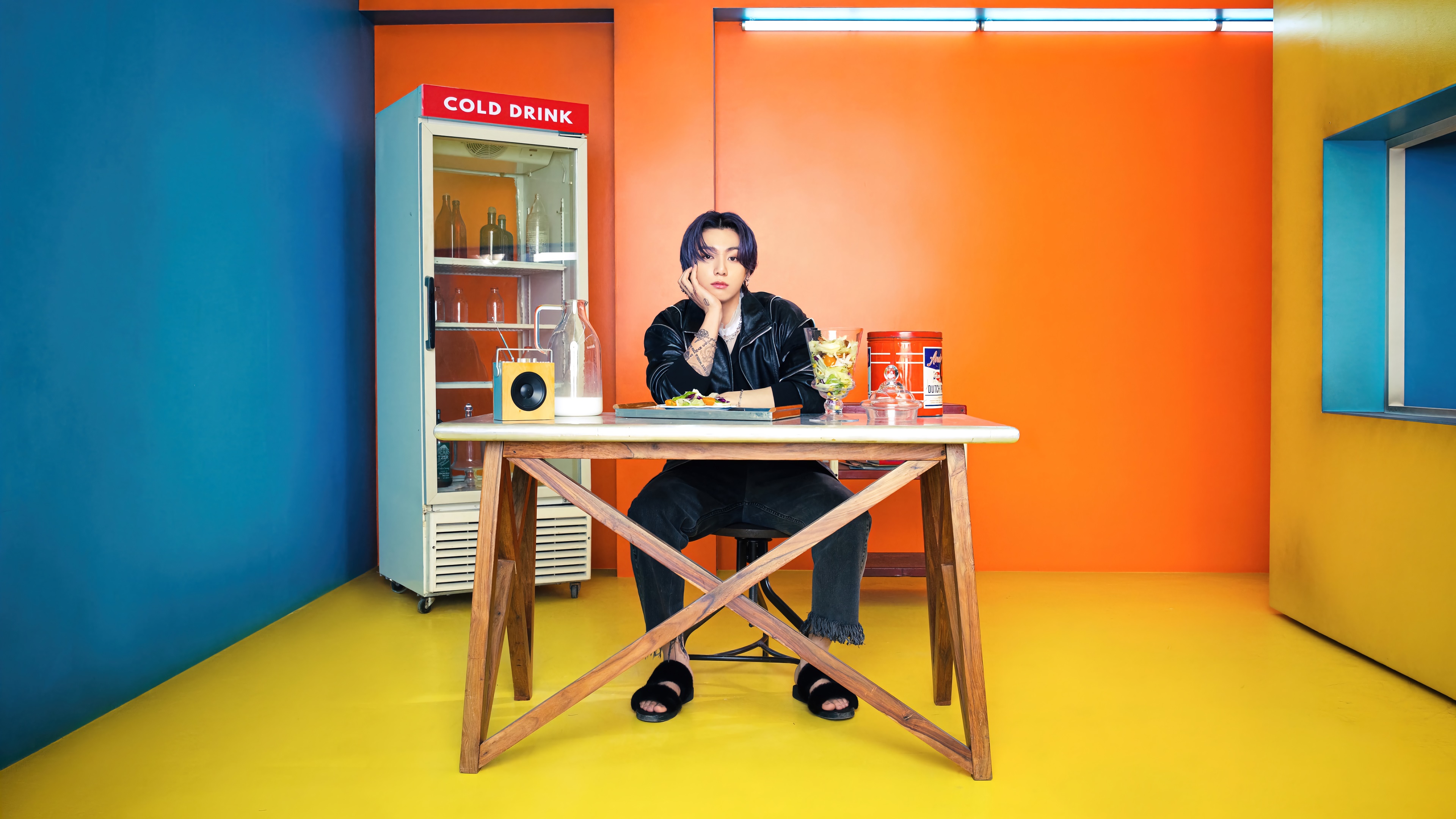 Jungkook from BTS sitting at a table with food HD Wallpaper