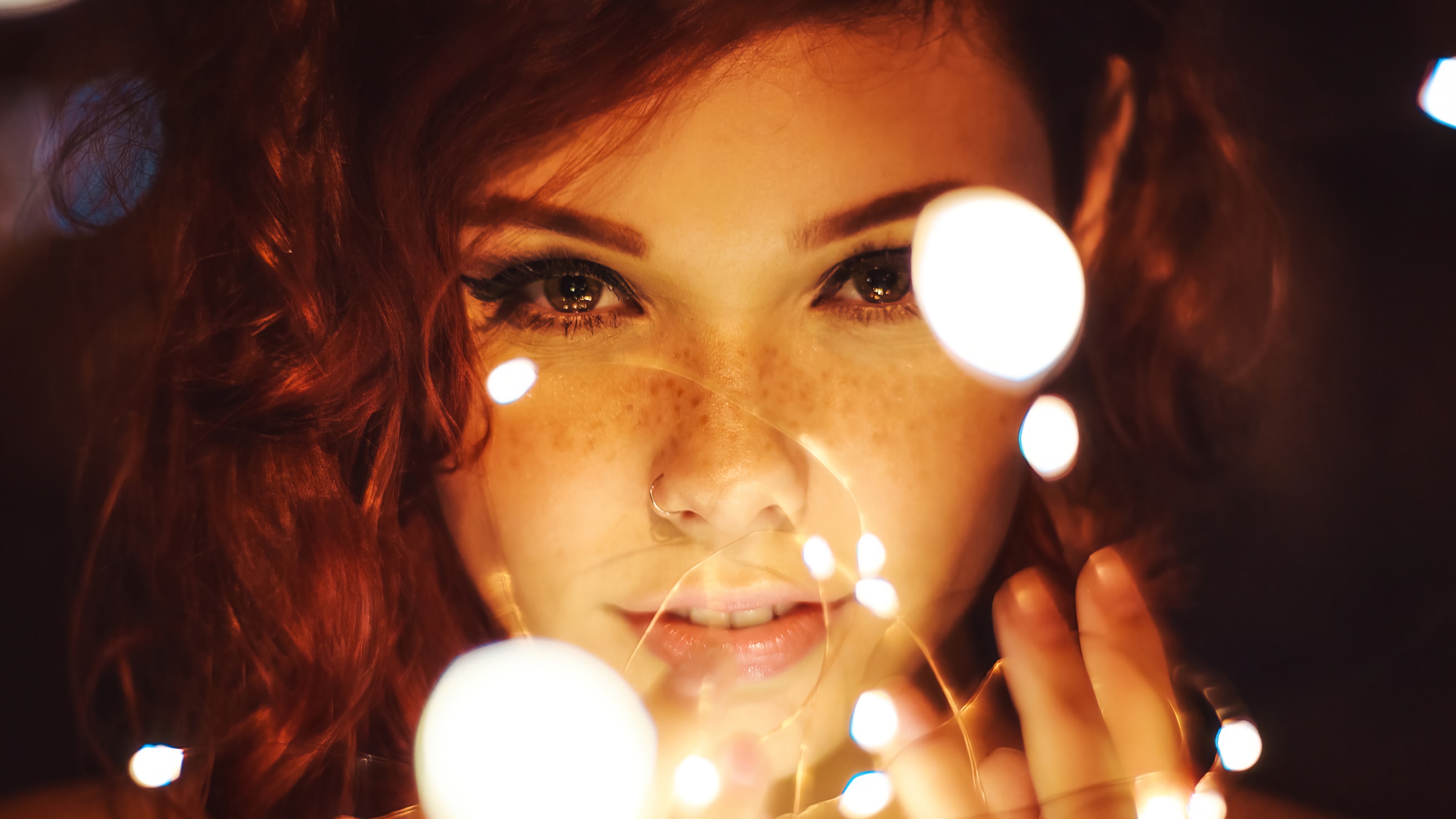 Beautiful woman with freckles and red hair surrounded by lights HD Wallpaper