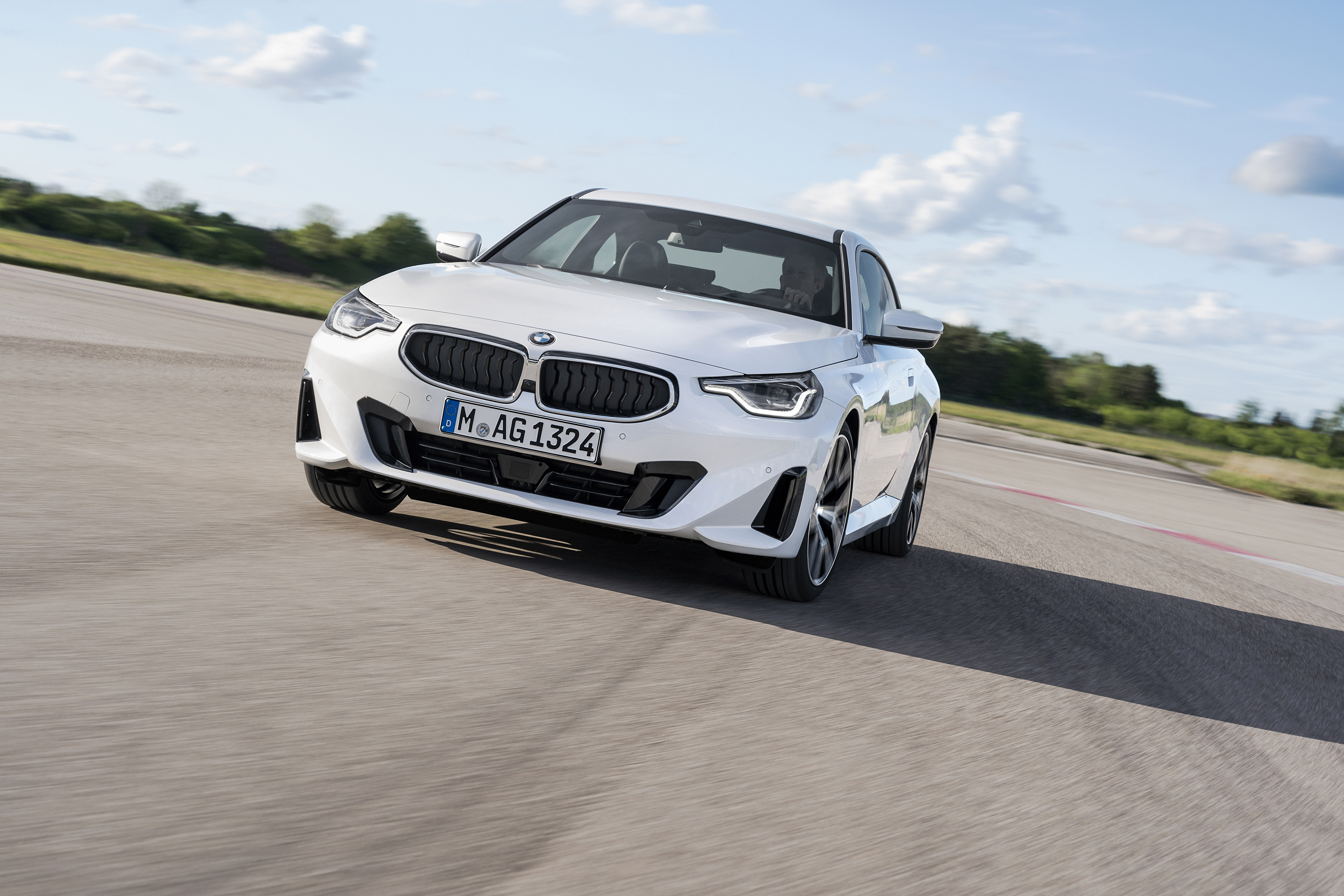 White BMW 220i Coupé driving on a track HD Wallpaper