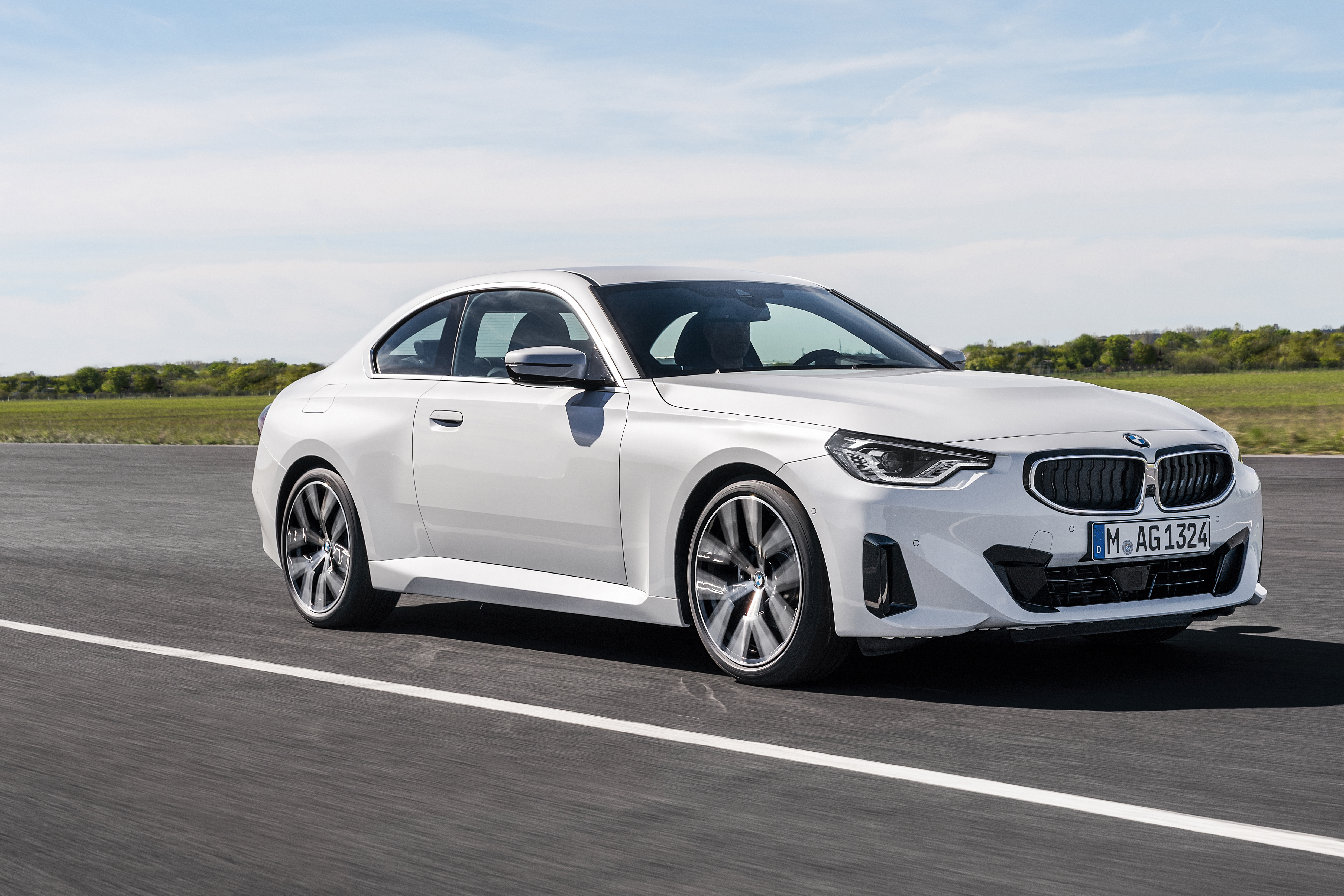 White BMW 220i Coupe driving on a road HD Wallpaper