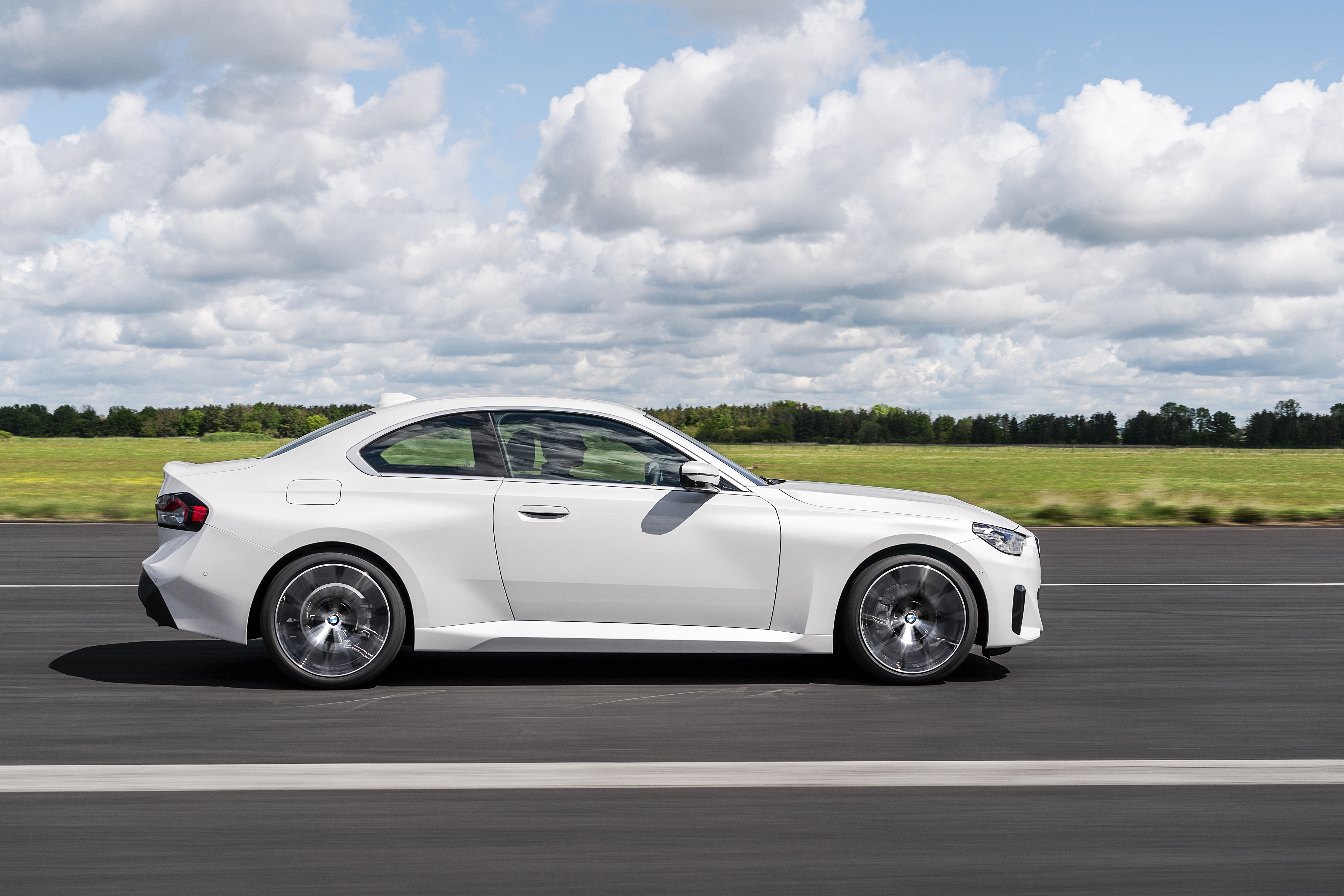White BMW 220i Coupe driving on a road HD Wallpaper
