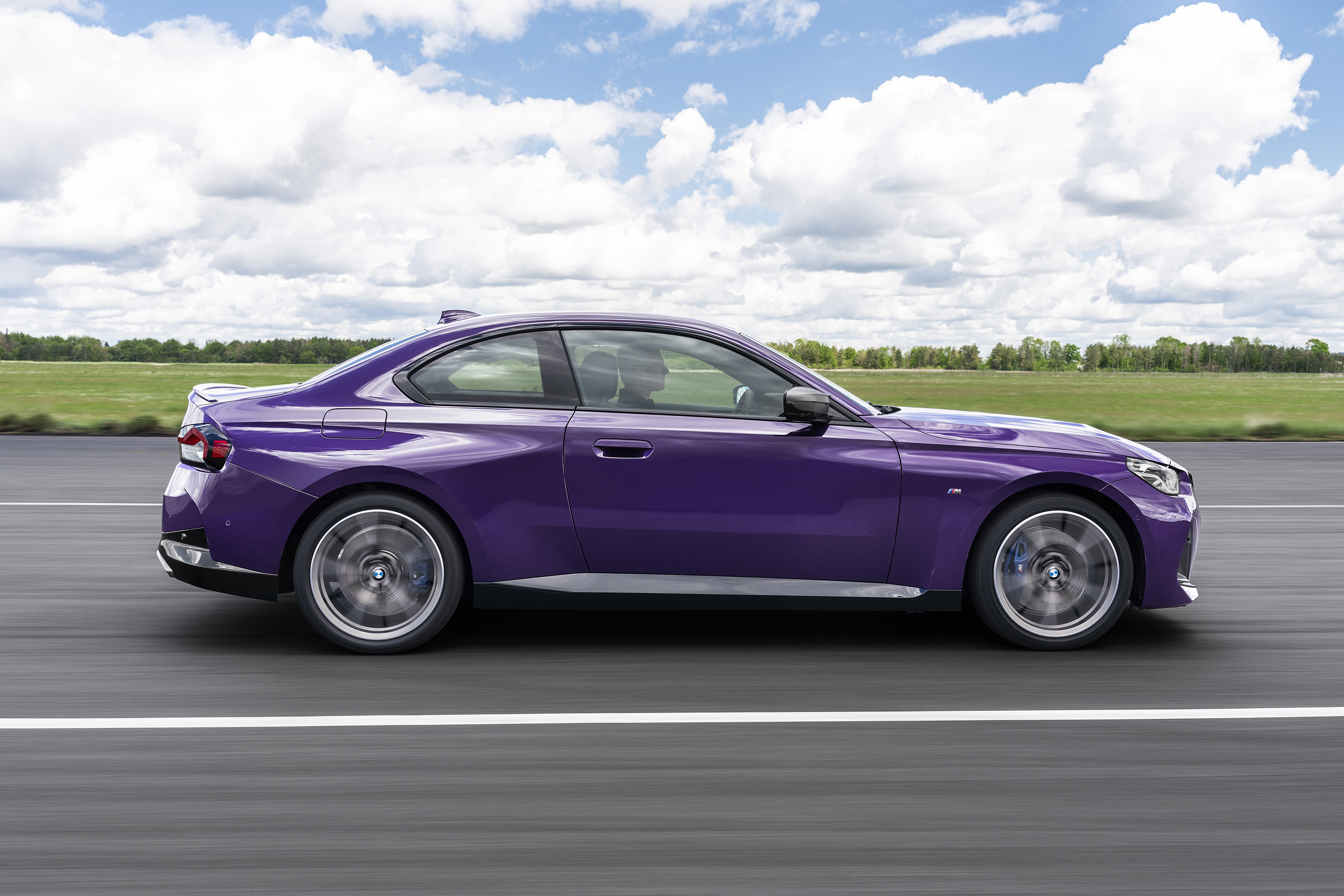Purple BMW M240i xDrive Coupé driving on a road HD Wallpaper