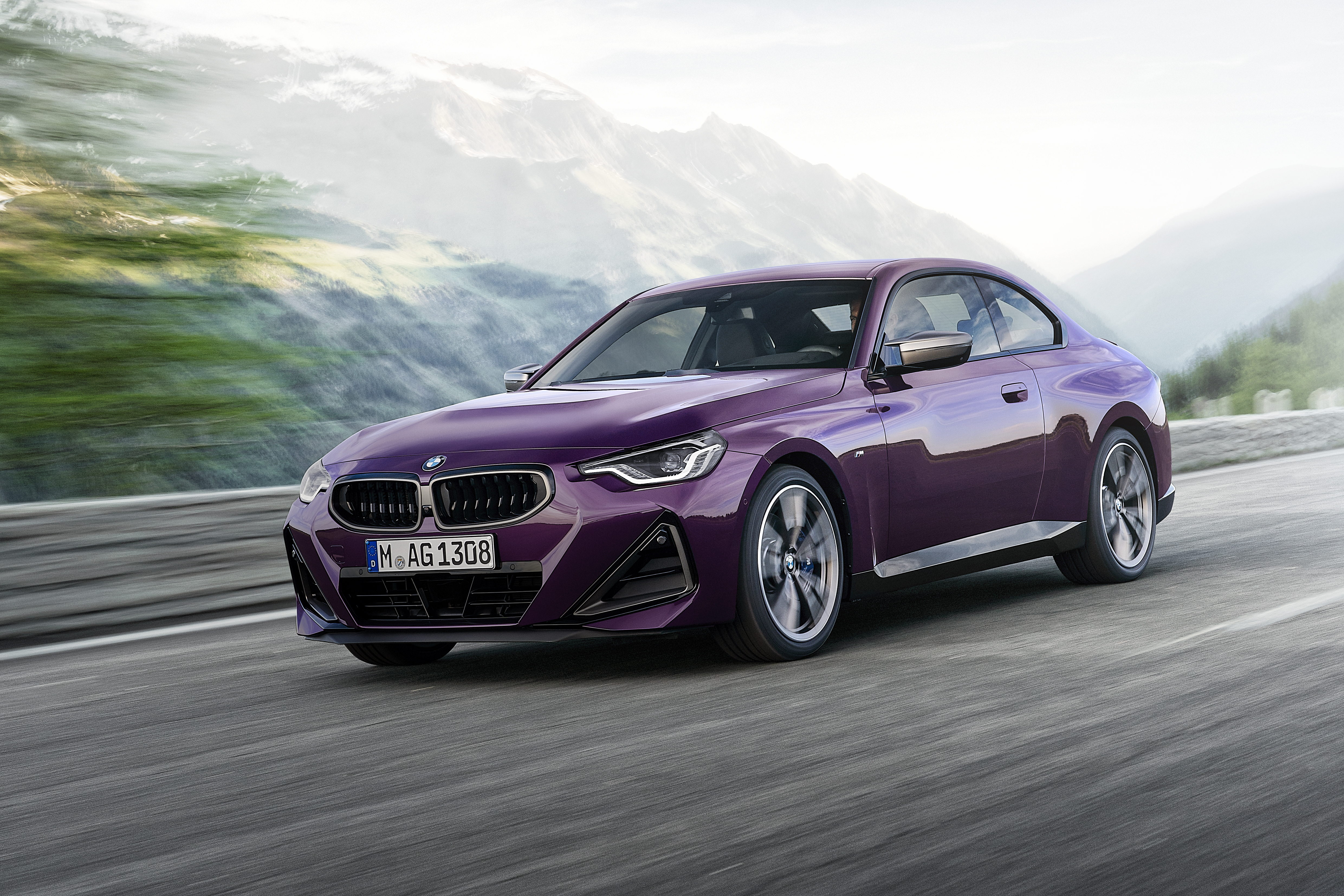 Purple BMW M240i xDrive Coupé driving on a mountain road HD Wallpaper