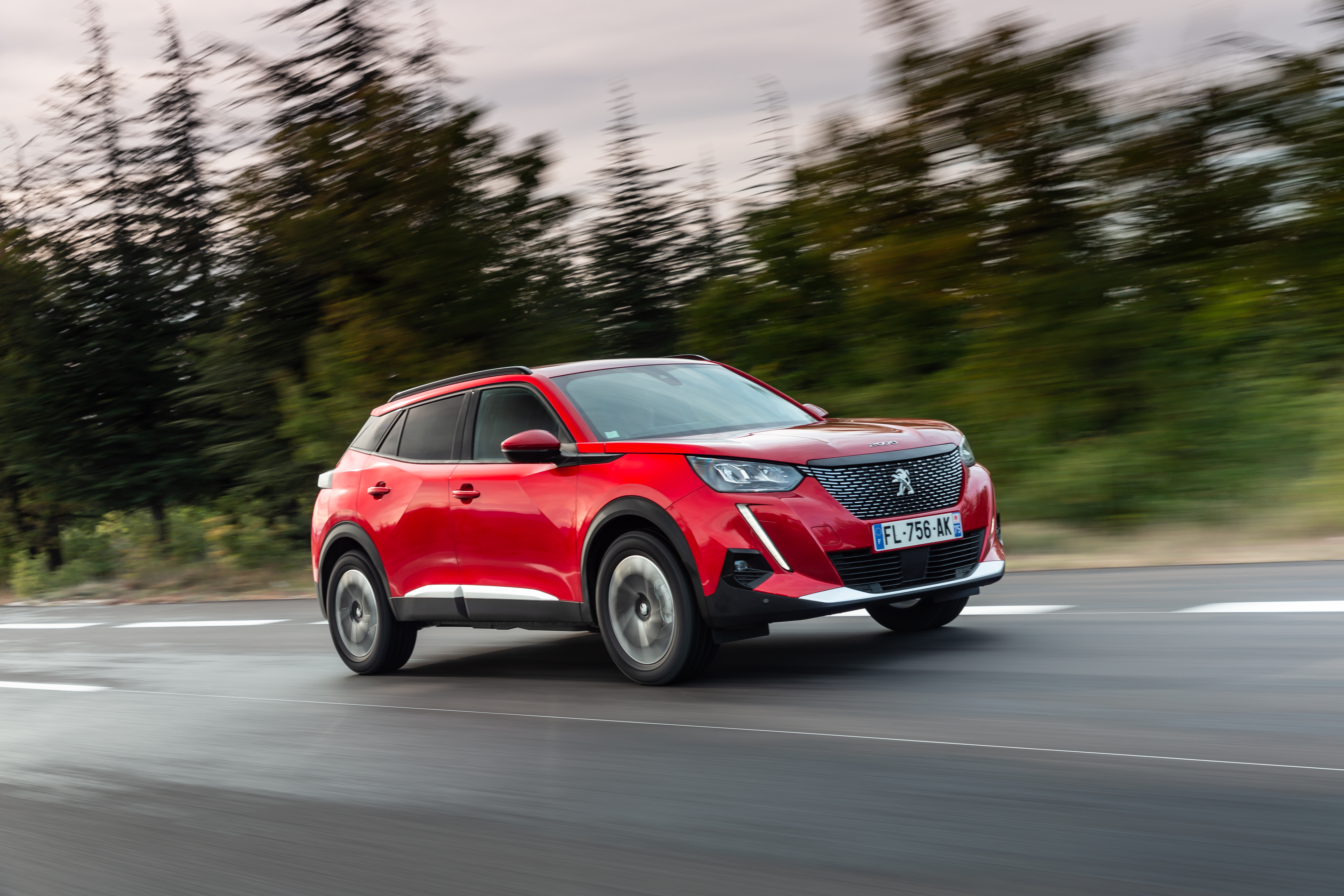 Red Peugeot 2008 SUV driving on road HD Wallpaper