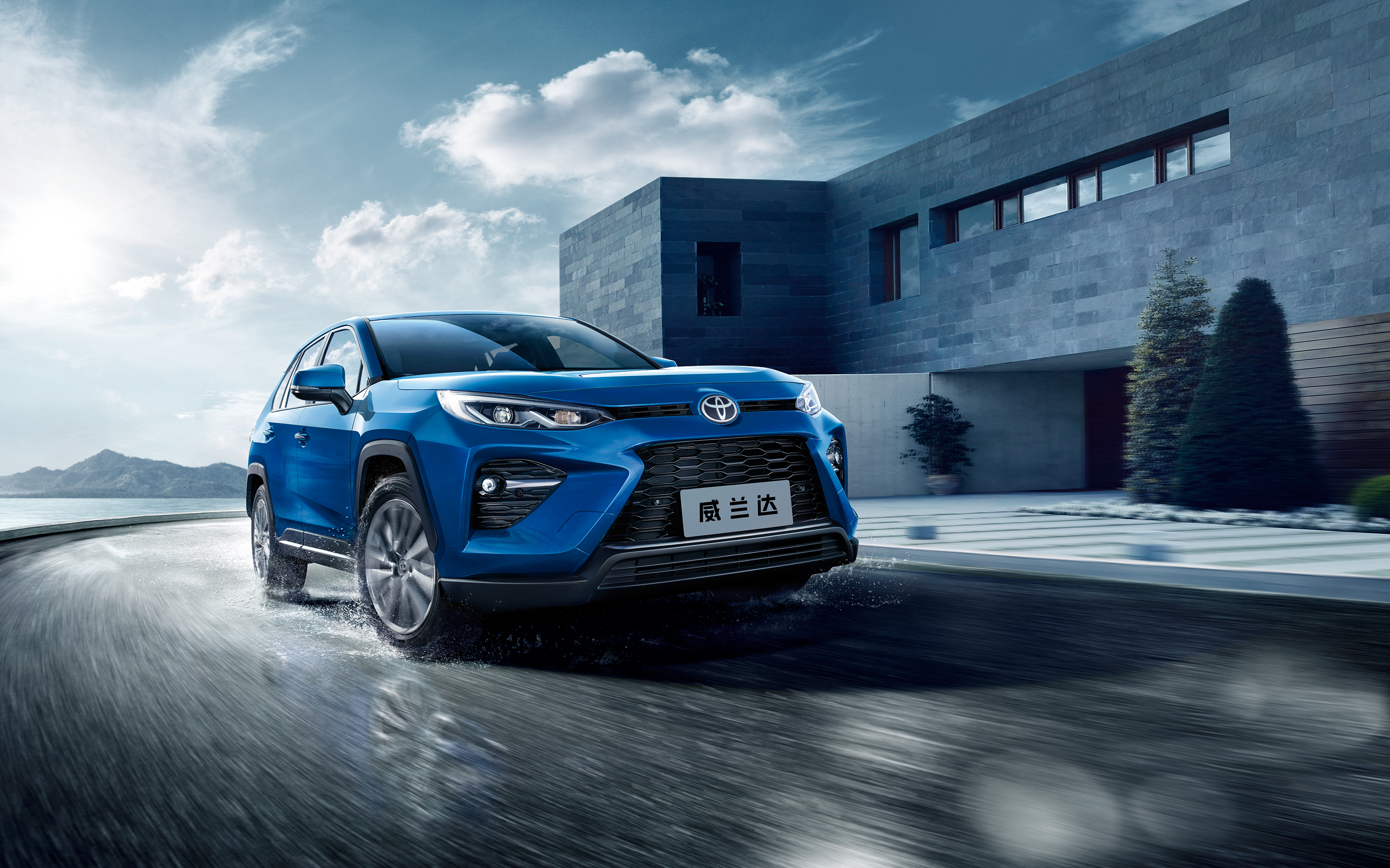 Blue Toyota Wildlander SUV driving on wet road HD Wallpaper