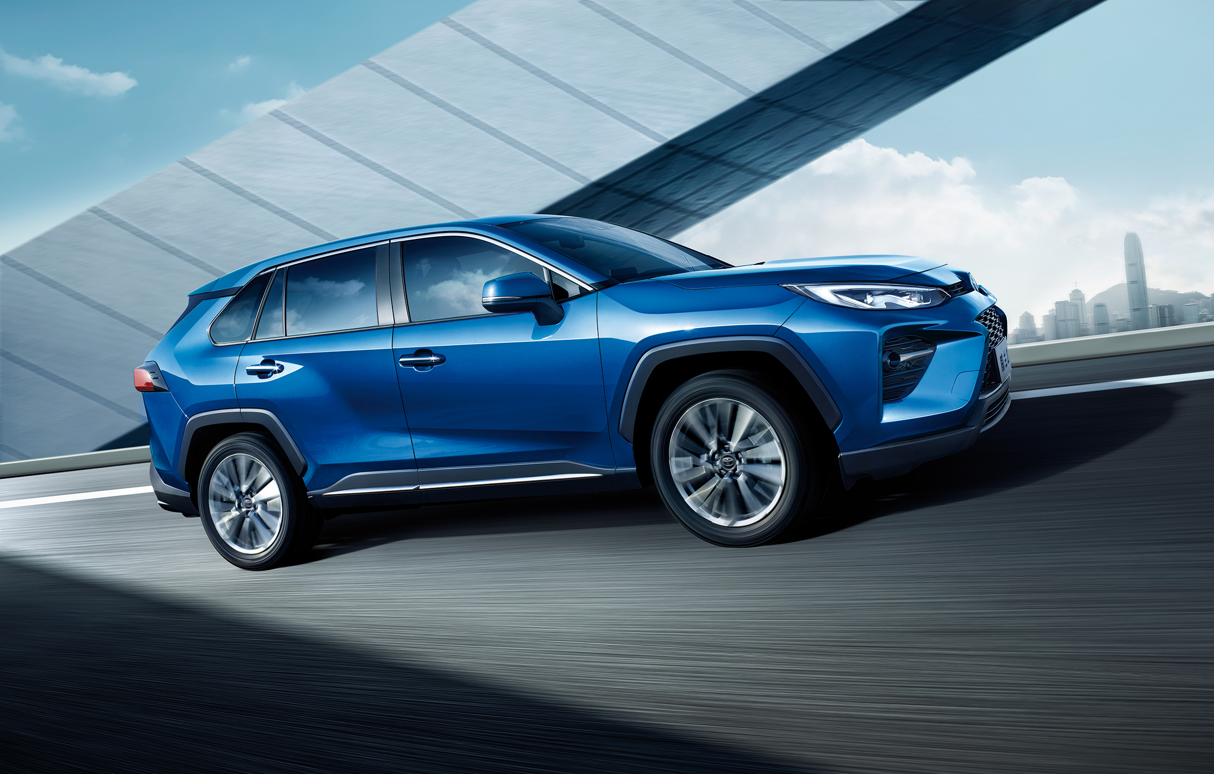 Blue Toyota Wildlander SUV driving on a highway HD Wallpaper