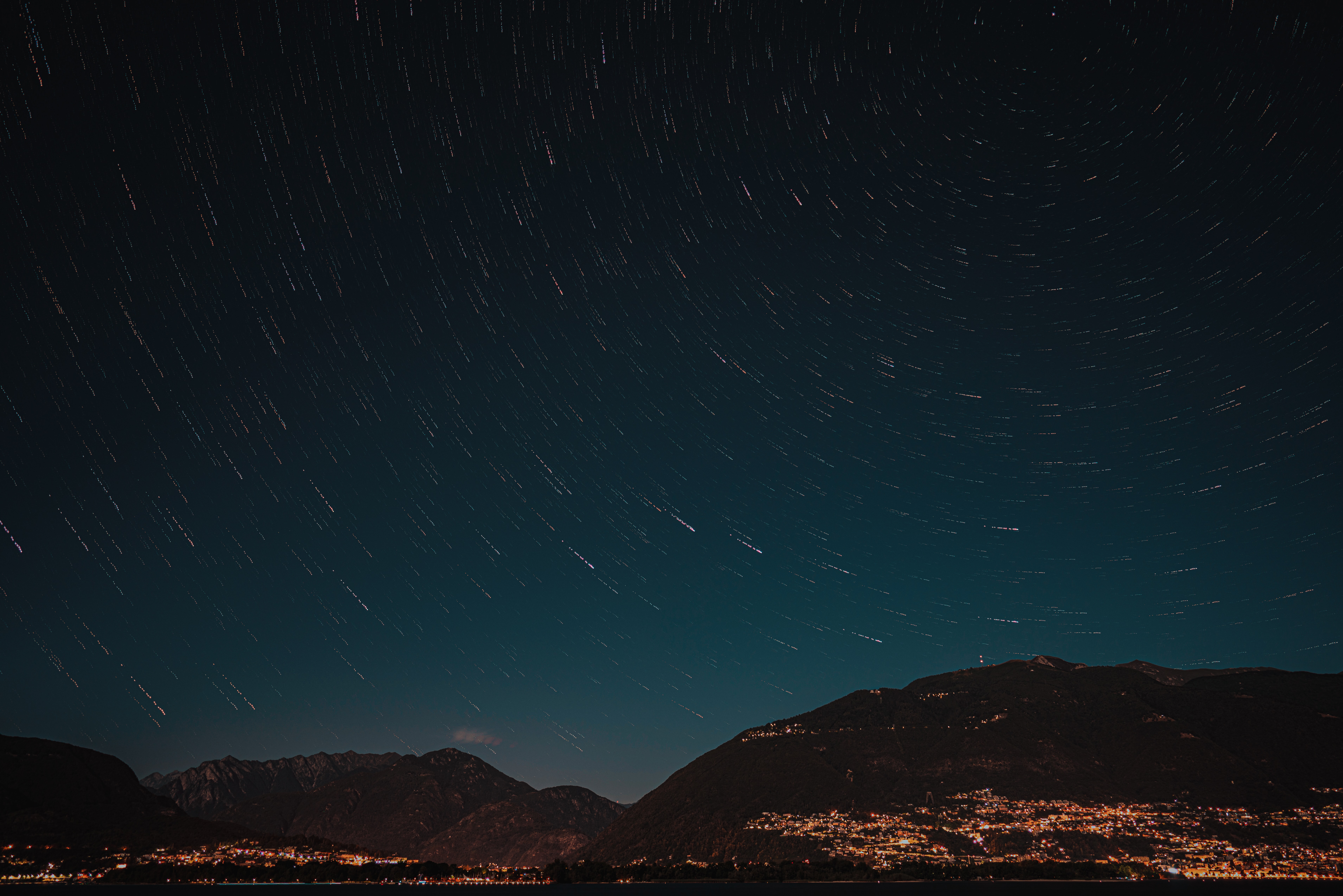 Star Trails Over Mountain Town at Night HD Wallpaper