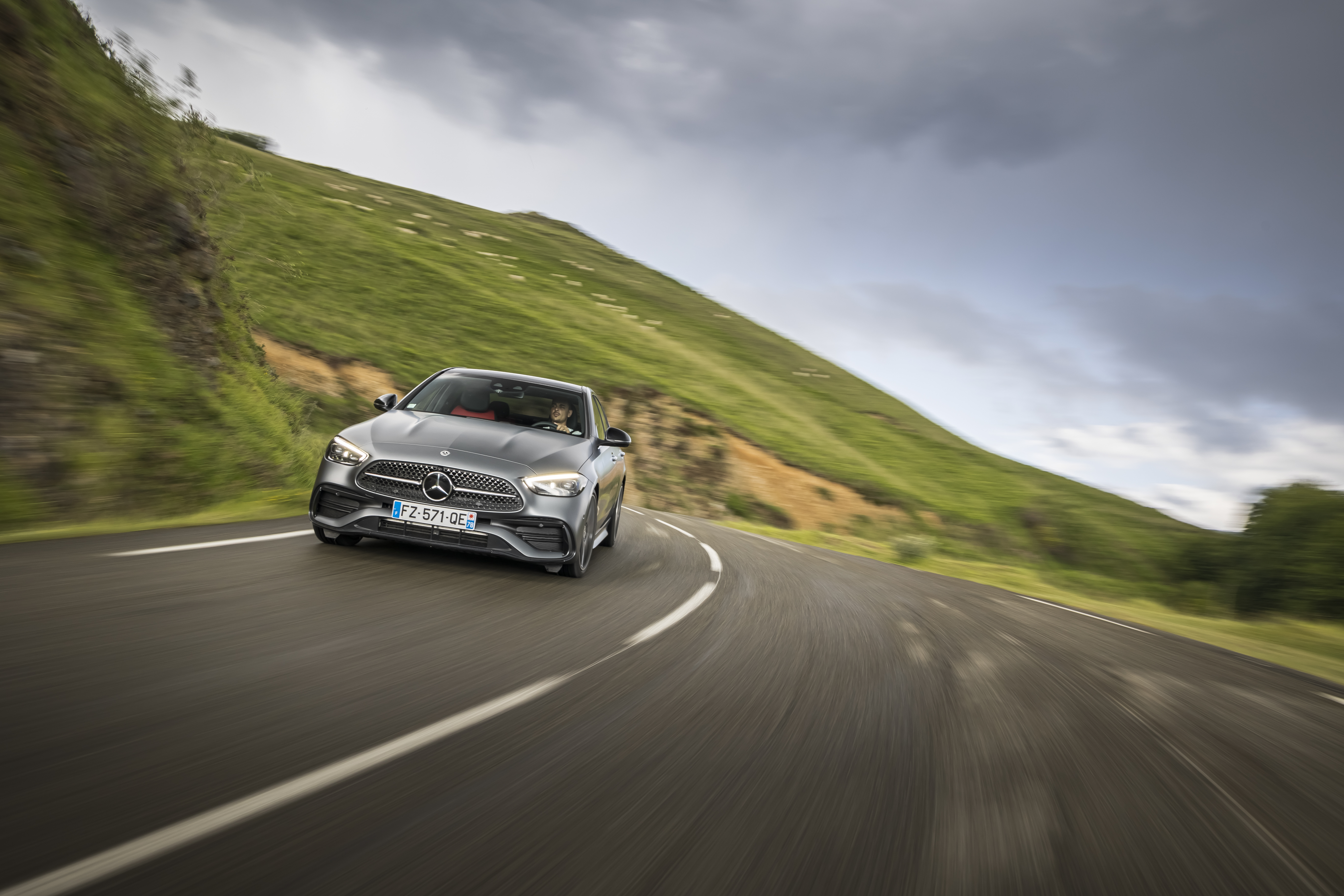 Grey Mercedes-Benz C 220 d AMG Line on a winding road HD Wallpaper