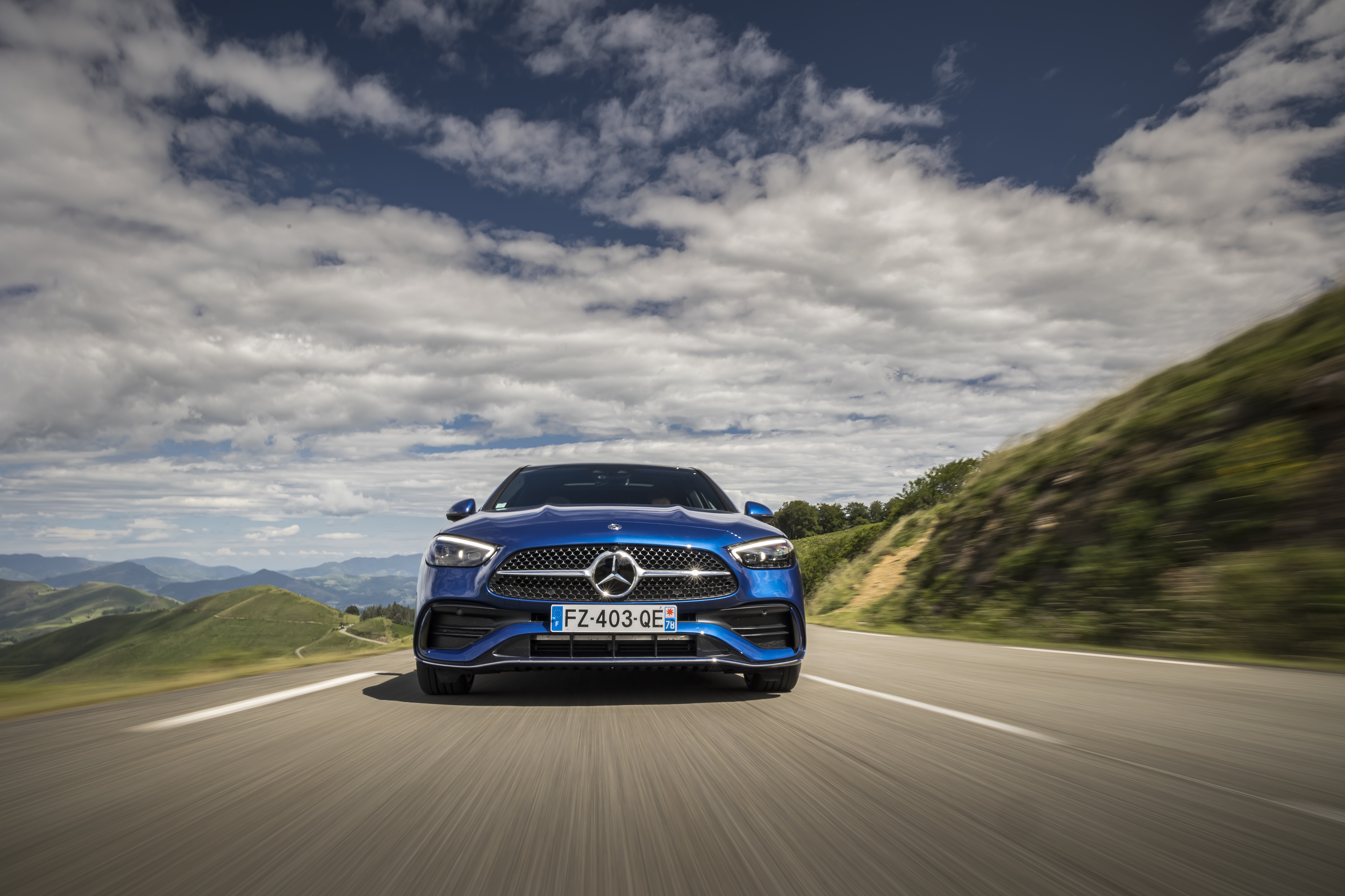 Blue Mercedes-Benz C 200 AMG Line on a Mountain Road HD Wallpaper