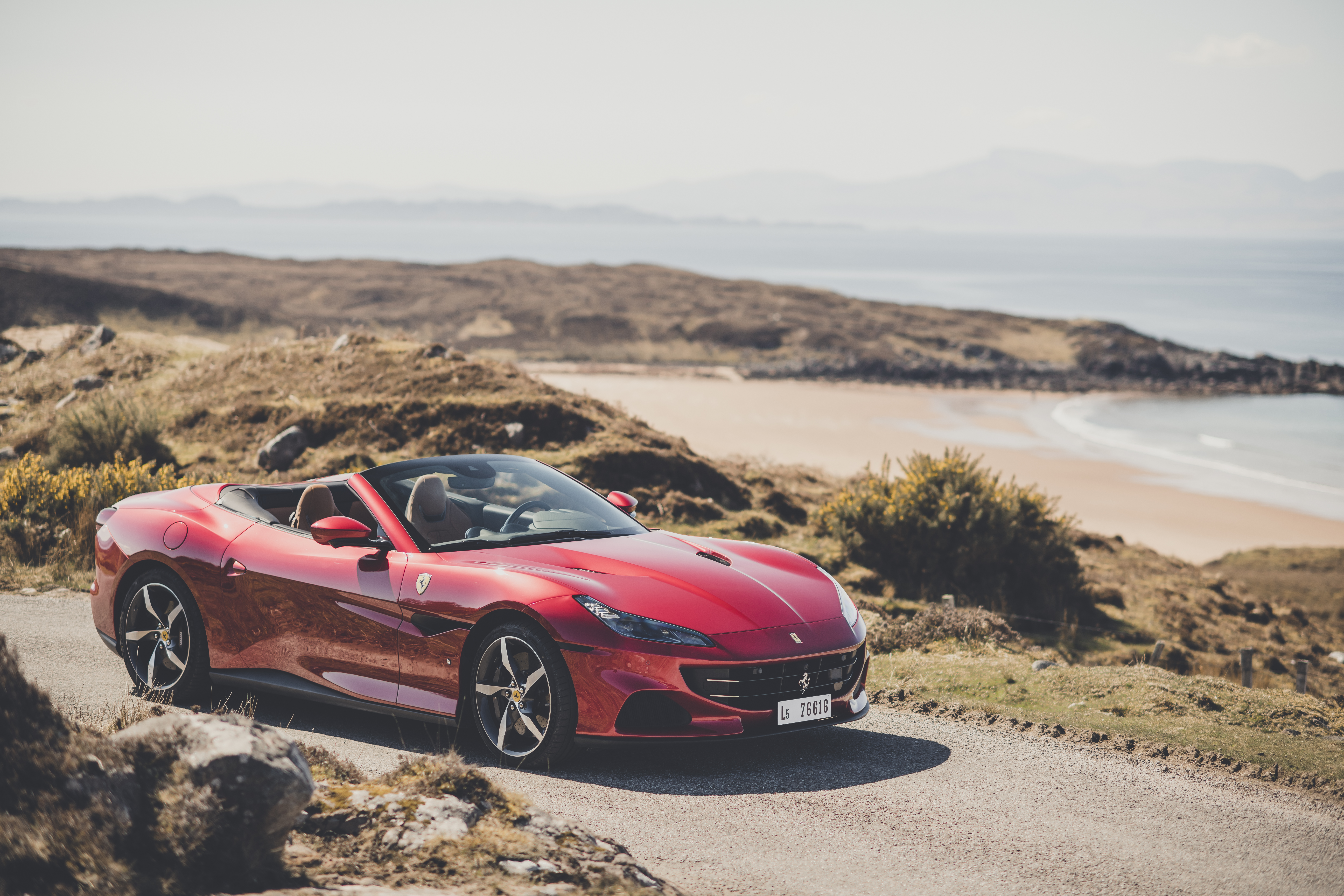 Red Ferrari Portofino M Convertible on Coastal Road HD Wallpaper