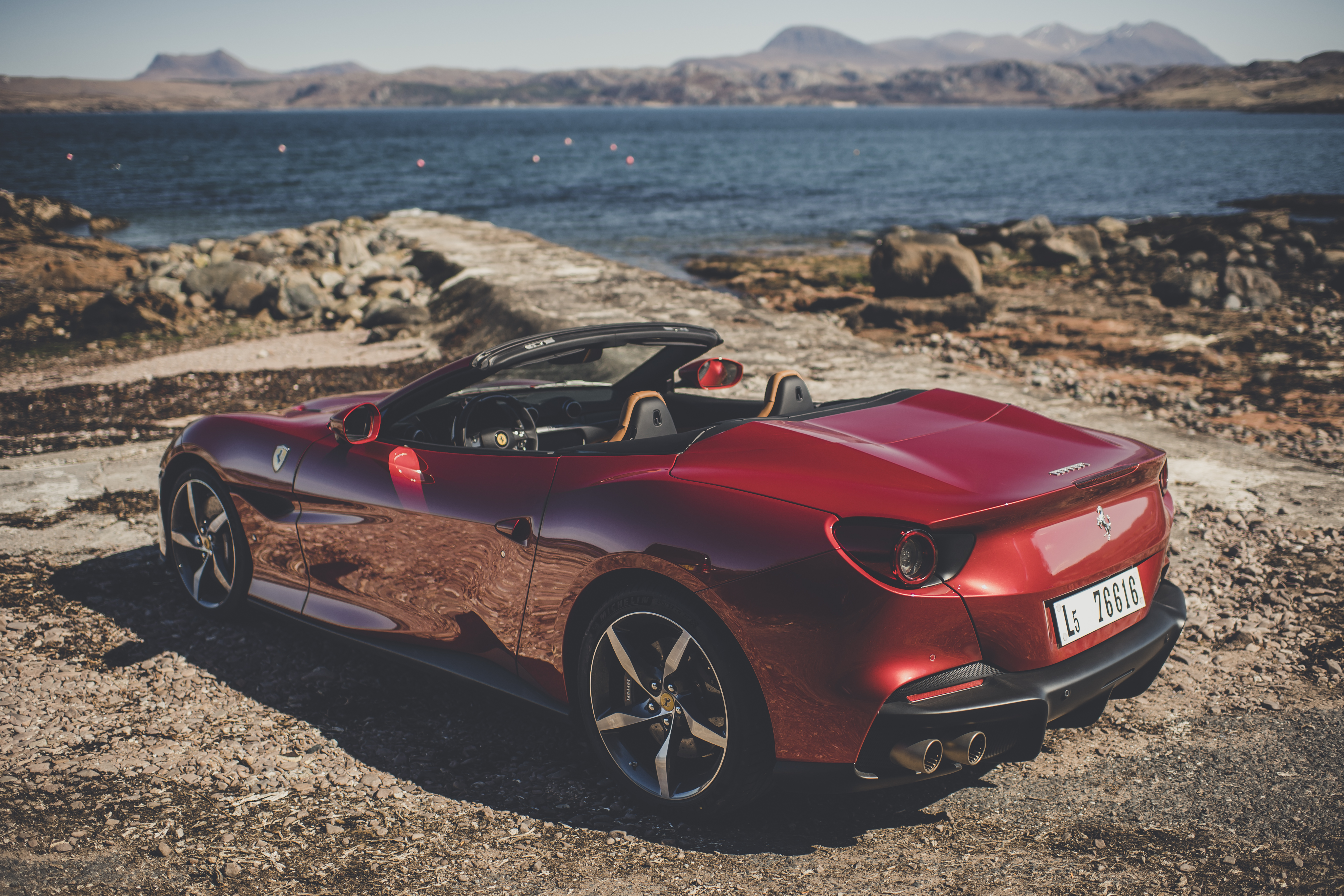 Red Ferrari Portofino M convertible by the sea HD Wallpaper