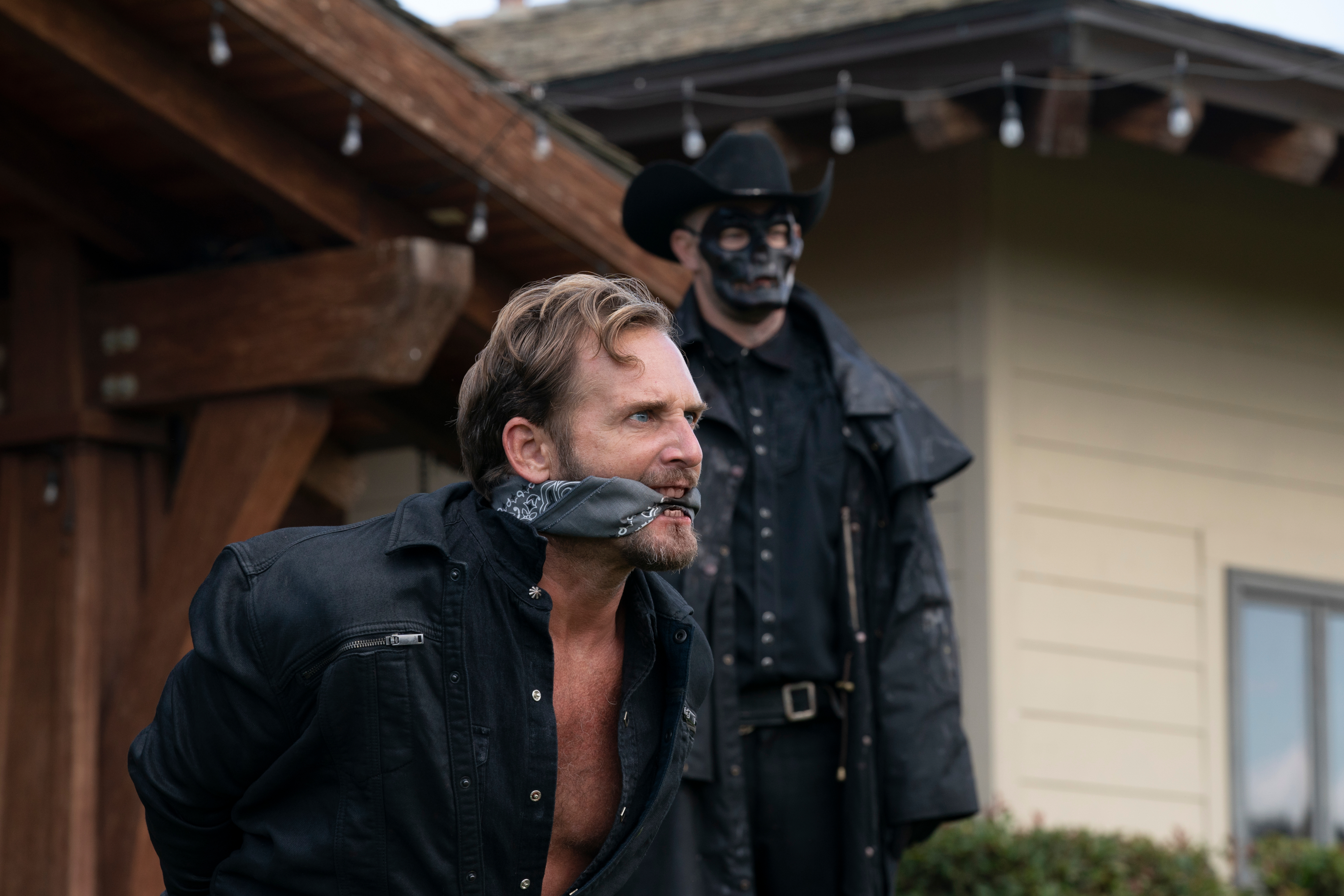 The Forever Purge: Man gagged with masked figure behind him HD Wallpaper