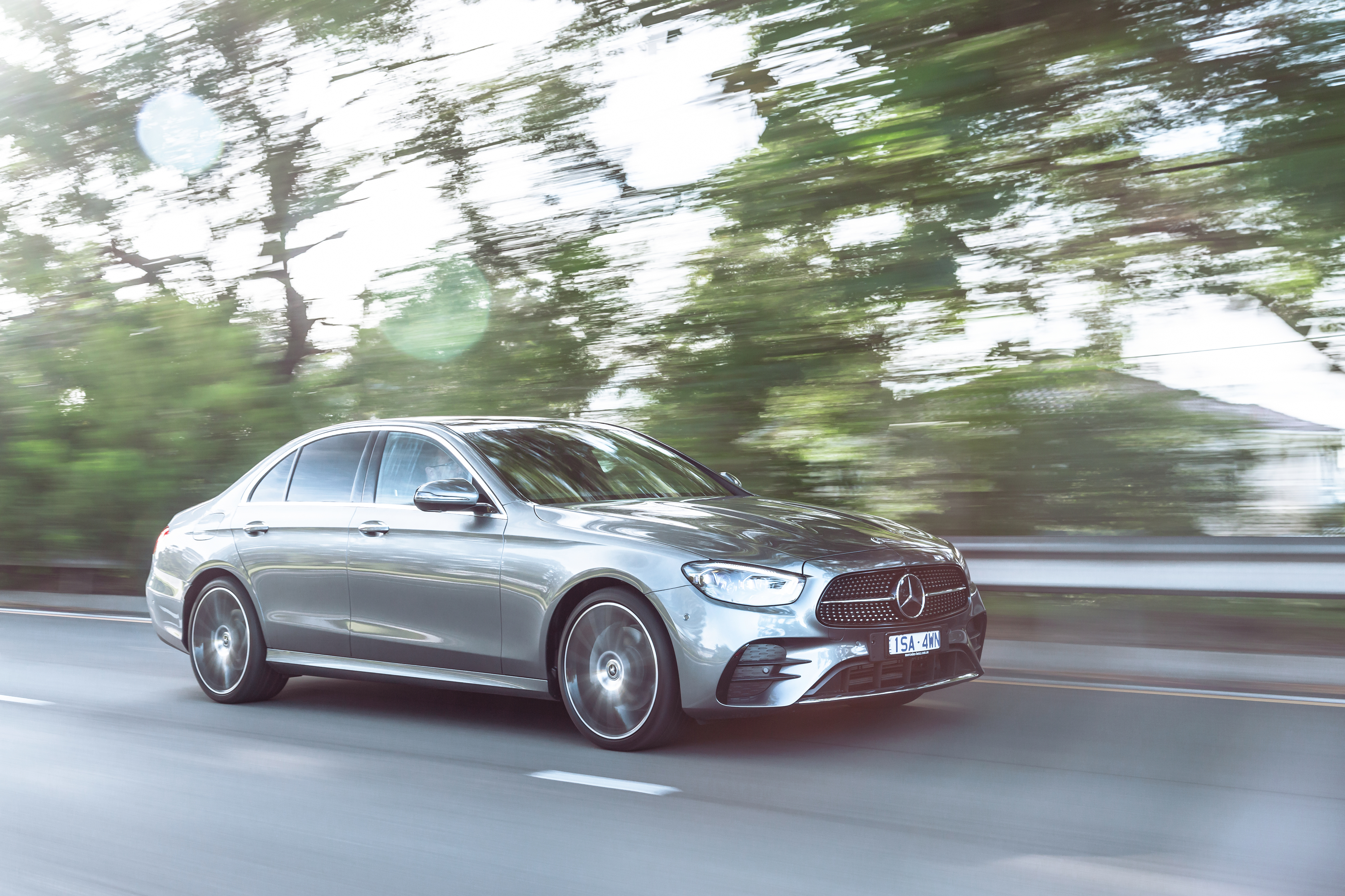 Silver Mercedes-Benz E 350 AMG Line driving on road HD Wallpaper