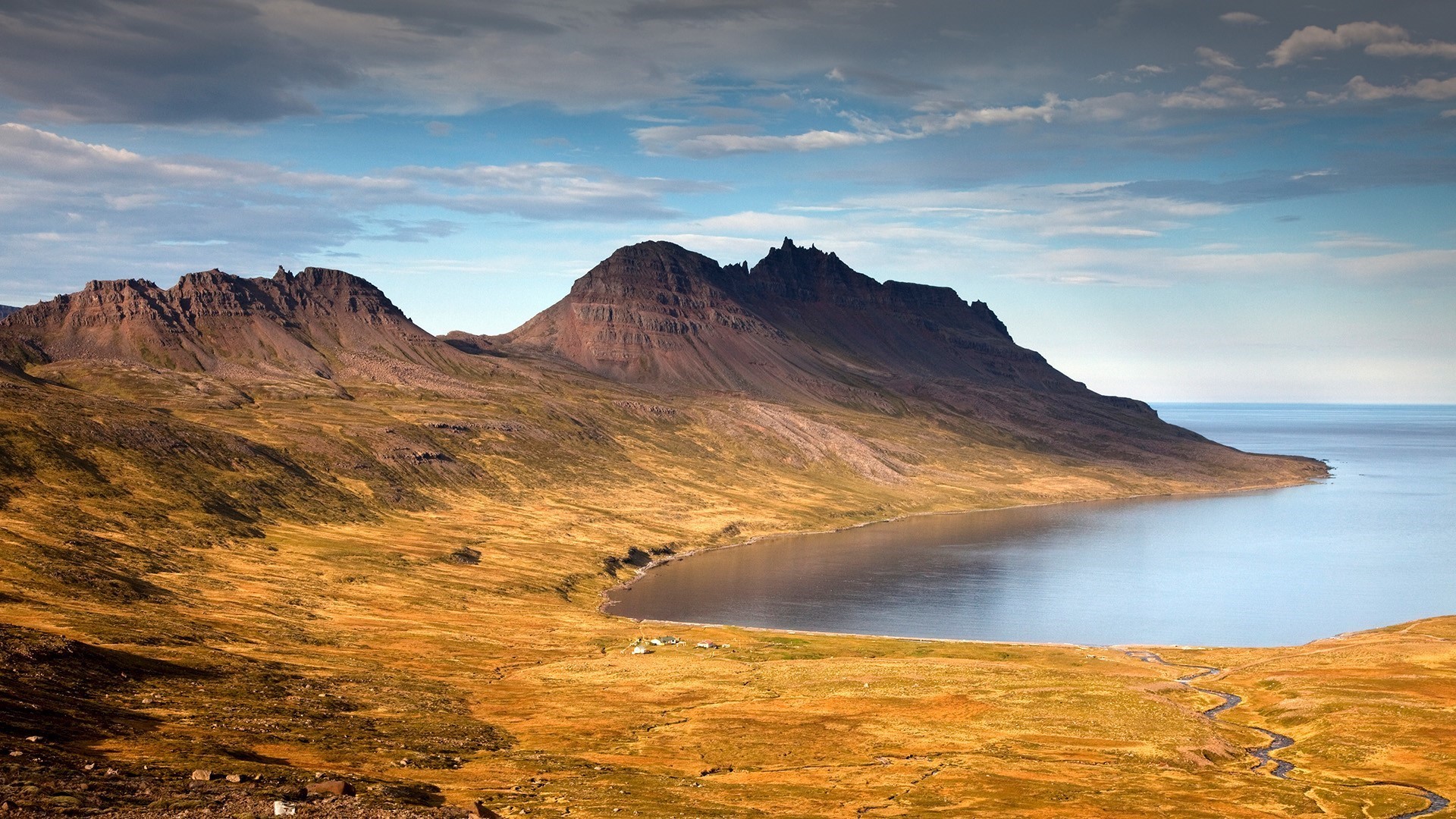 Mountainous fjord landscape with calm sea and cloudy sky HD Wallpaper