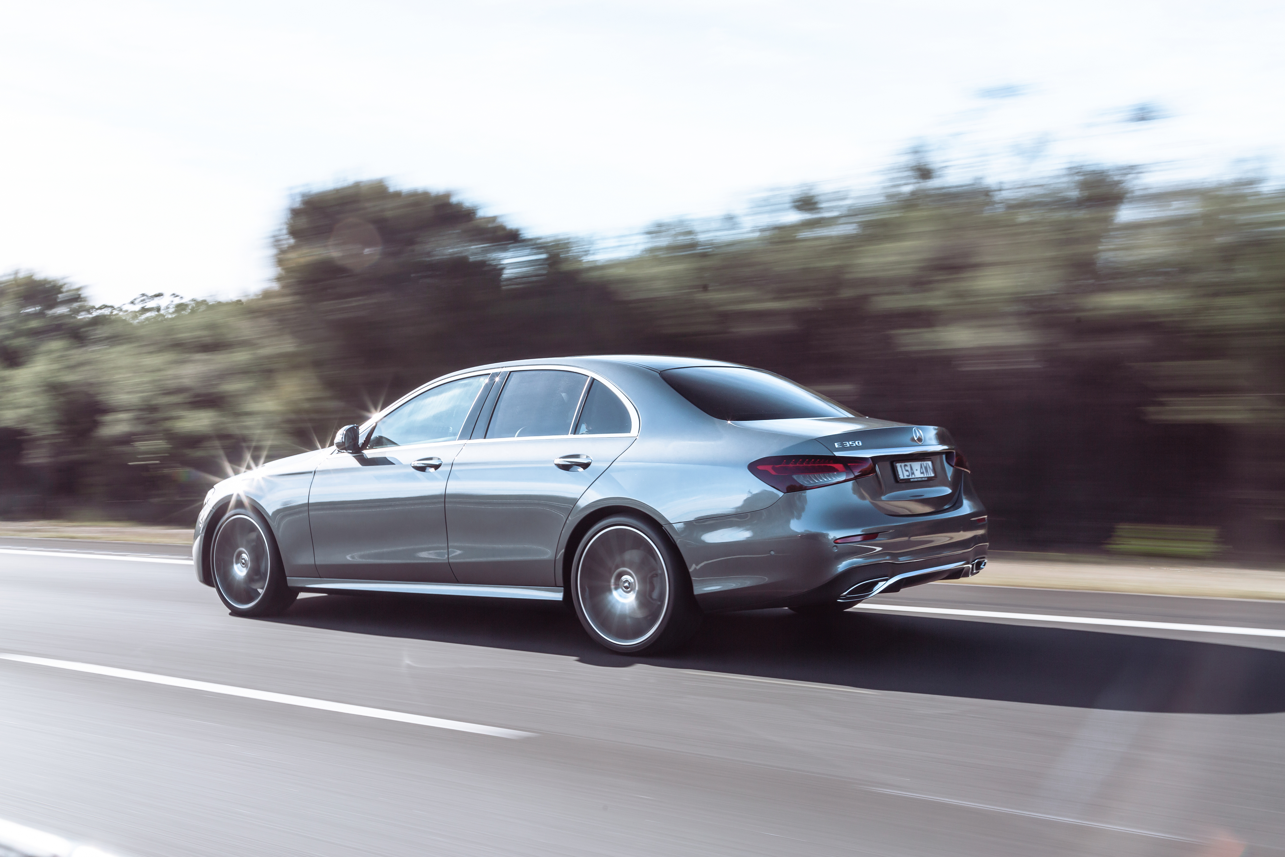 Silver Mercedes-Benz E 350 AMG Line driving on highway HD Wallpaper