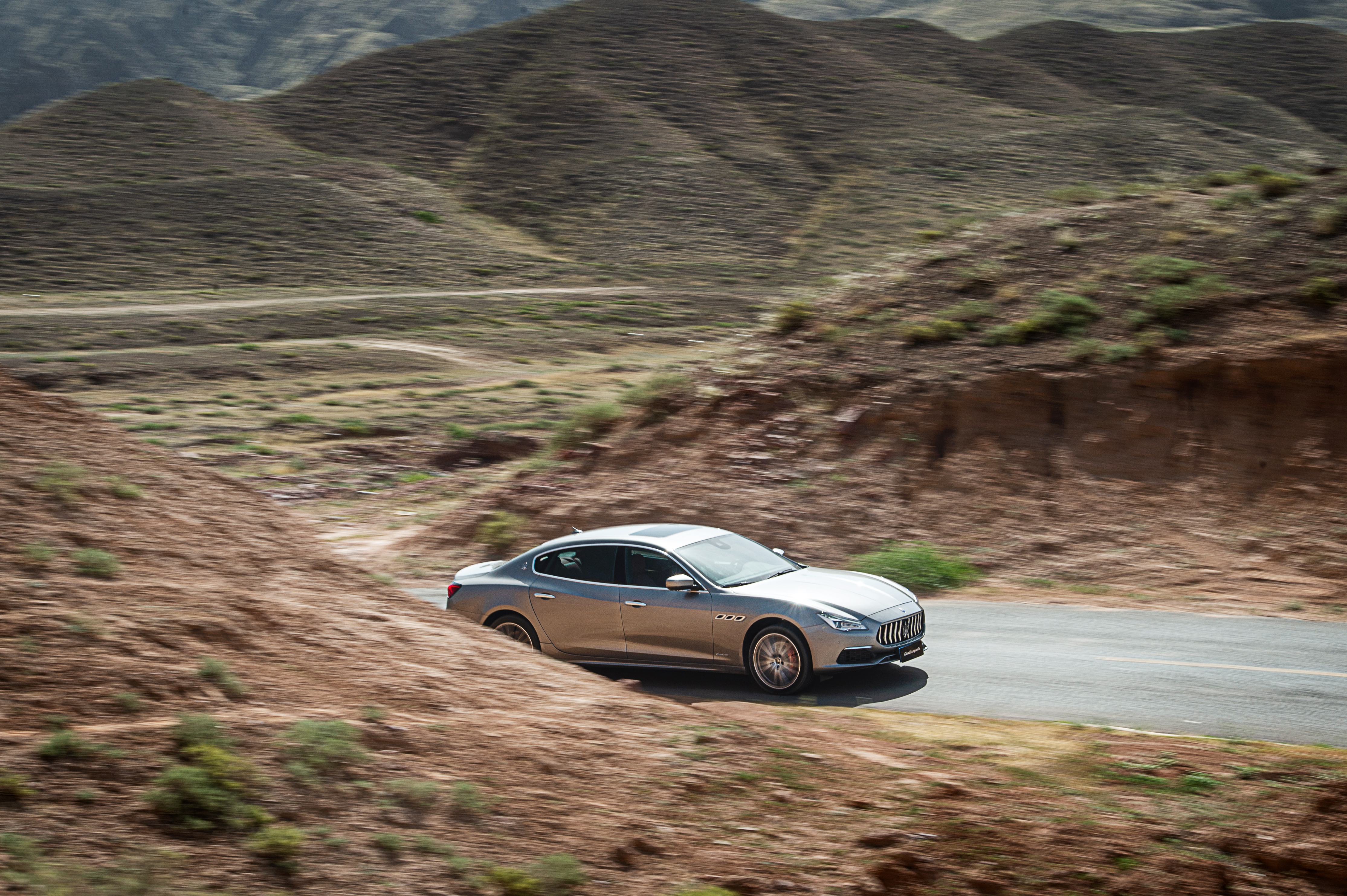 Silver Maserati Quattroporte S Q4 GranLusso on a mountain road HD Wallpaper