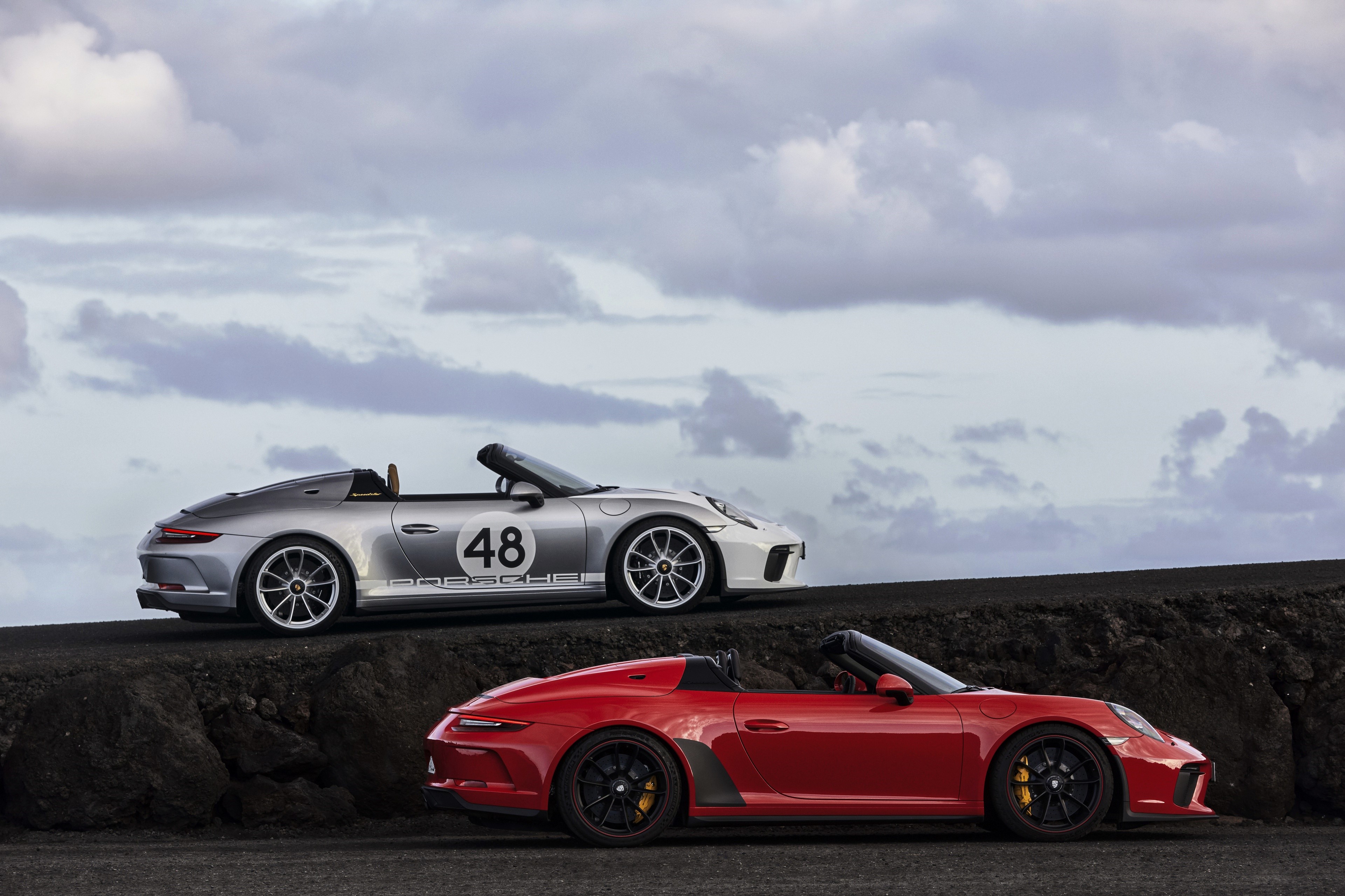 Two Porsche 911 convertible cars, one red and one silver HD Wallpaper