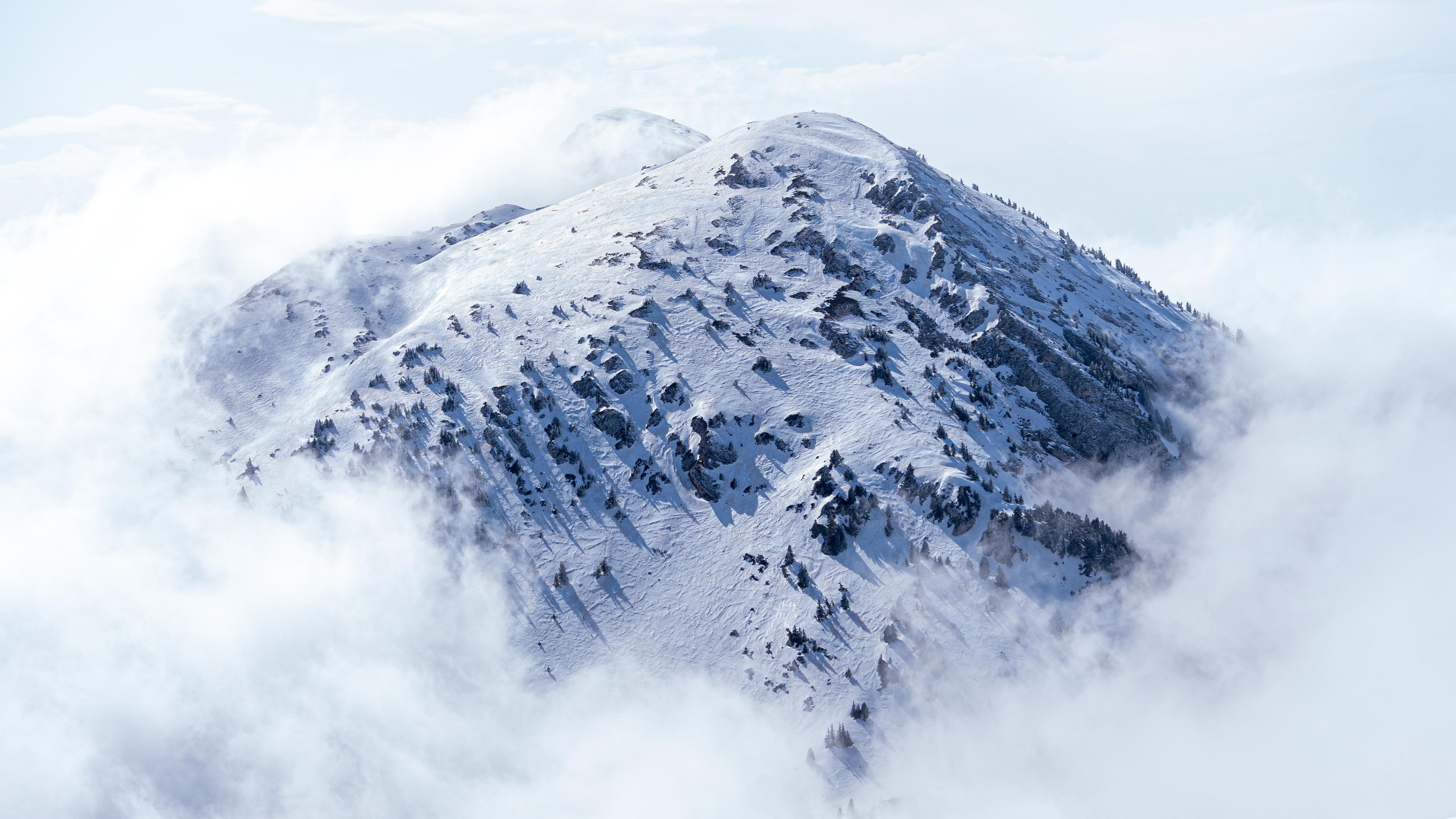 Snowy mountain peak emerging from clouds in France HD Wallpaper