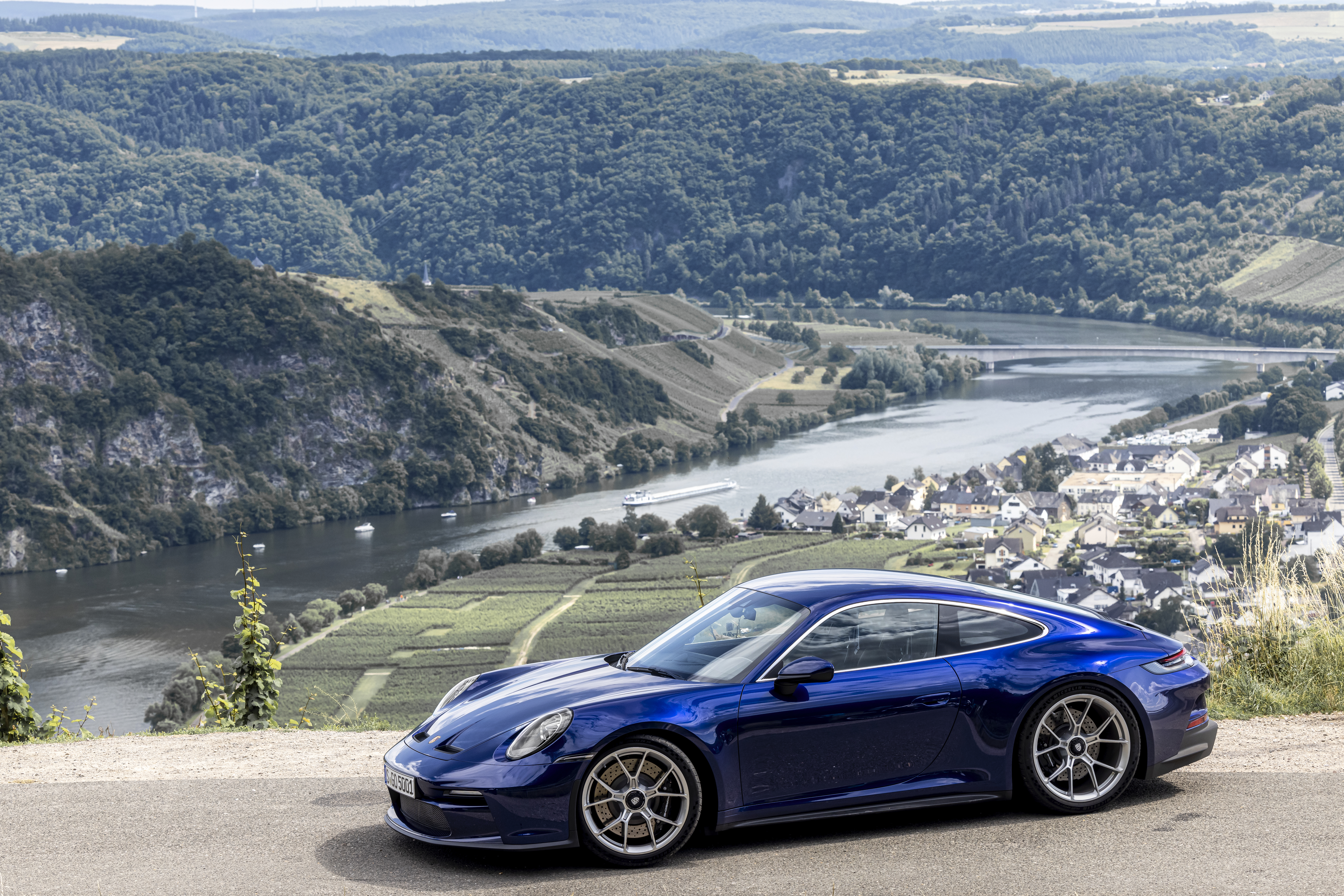 Blue Porsche 911 GT3 Touring with scenic river view HD Wallpaper