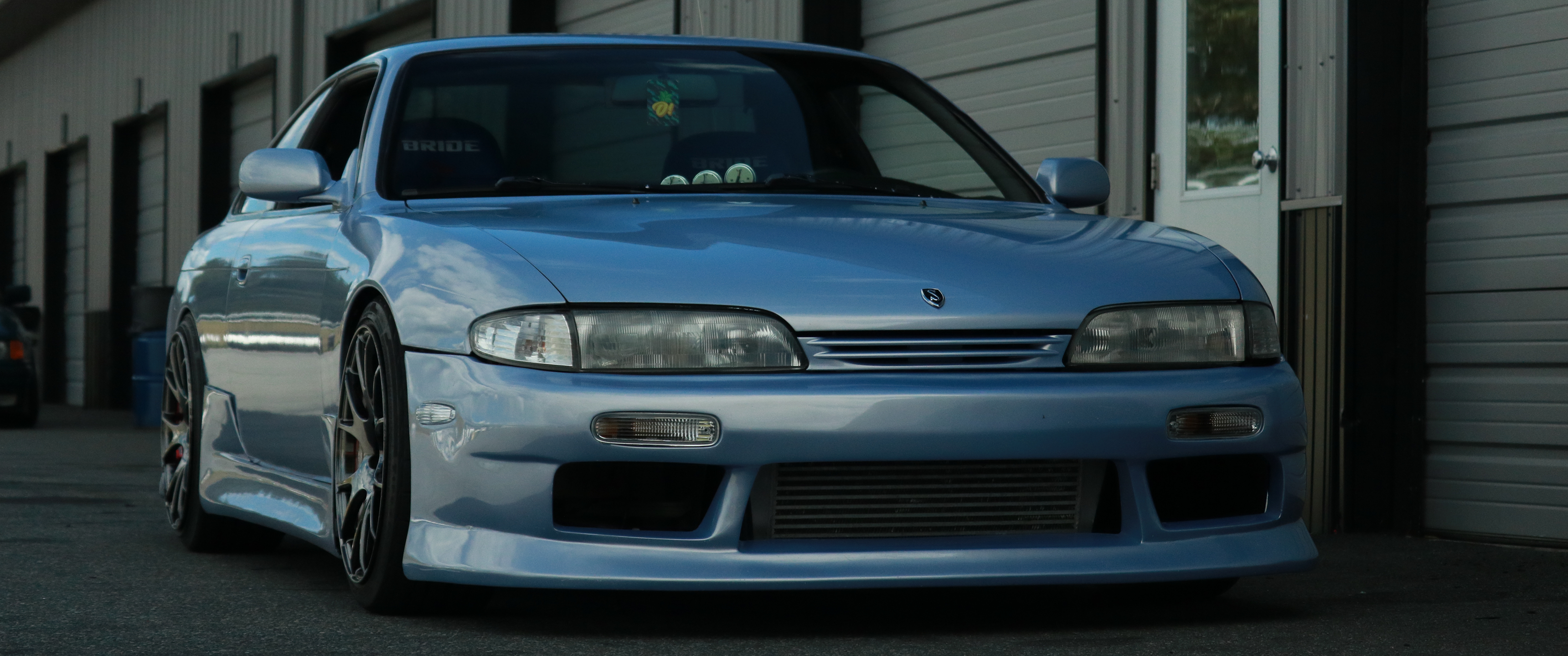Blue Nissan Silvia S14 parked outside garage HD Wallpaper