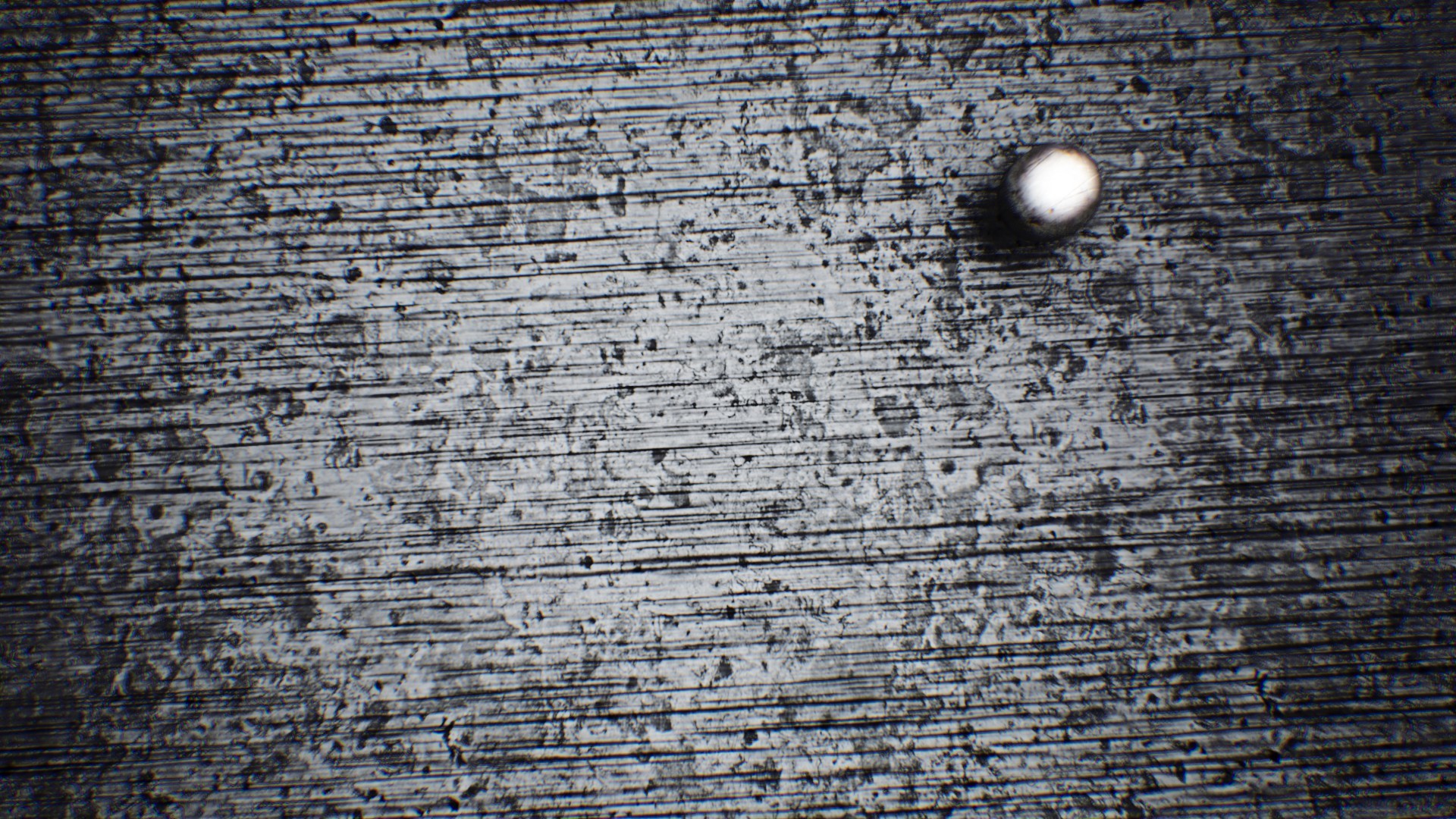 Close-up of a scratched metal surface with a small metallic sphere HD Wallpaper