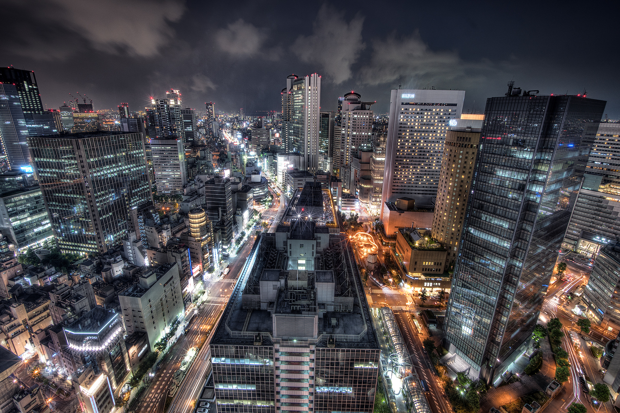 Nighttime cityscape of a Japanese city with skyscrapers HD Wallpaper