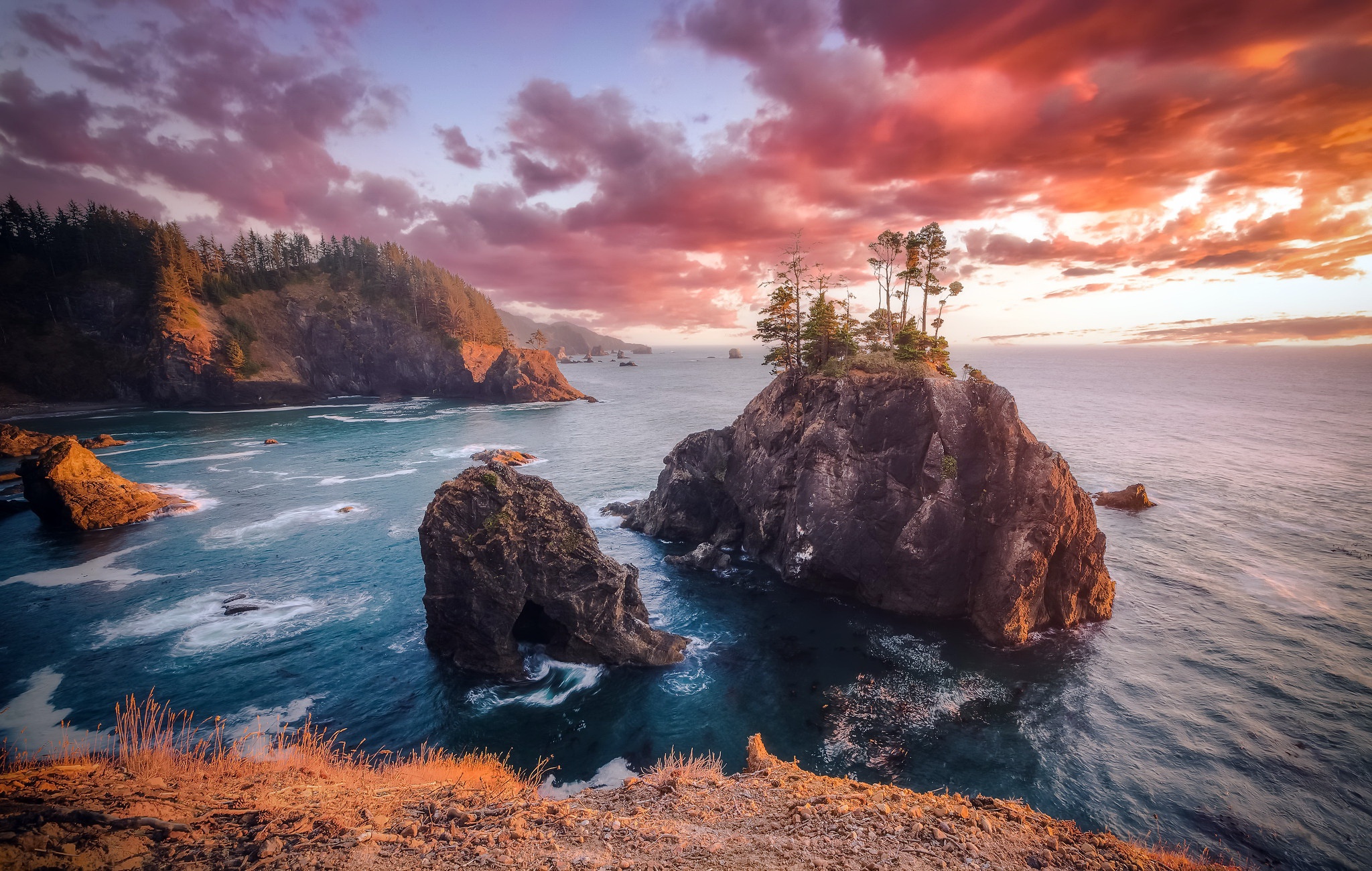 Dramatic sunset over rocky coastline with sea stacks HD Wallpaper