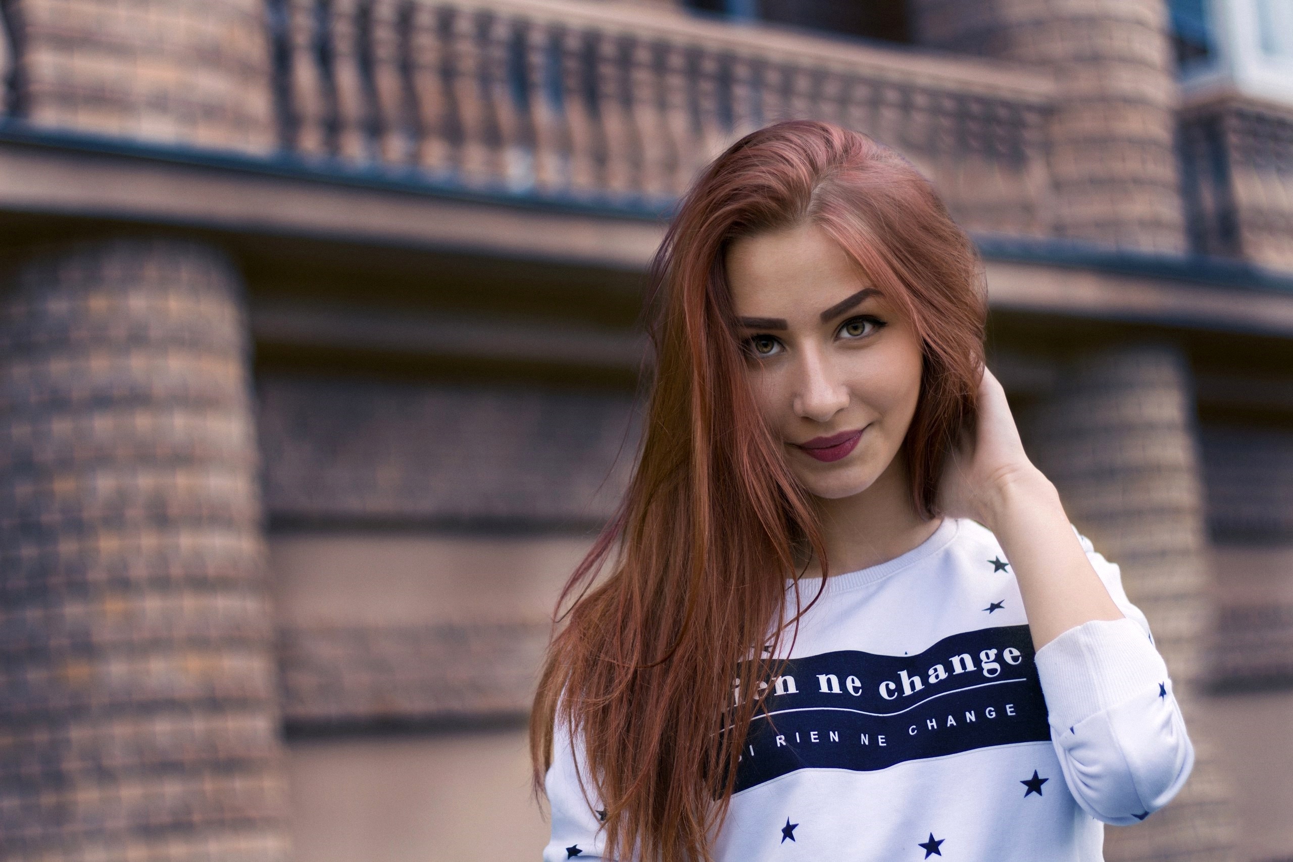 Young woman with red hair wearing a white sweatshirt HD Wallpaper