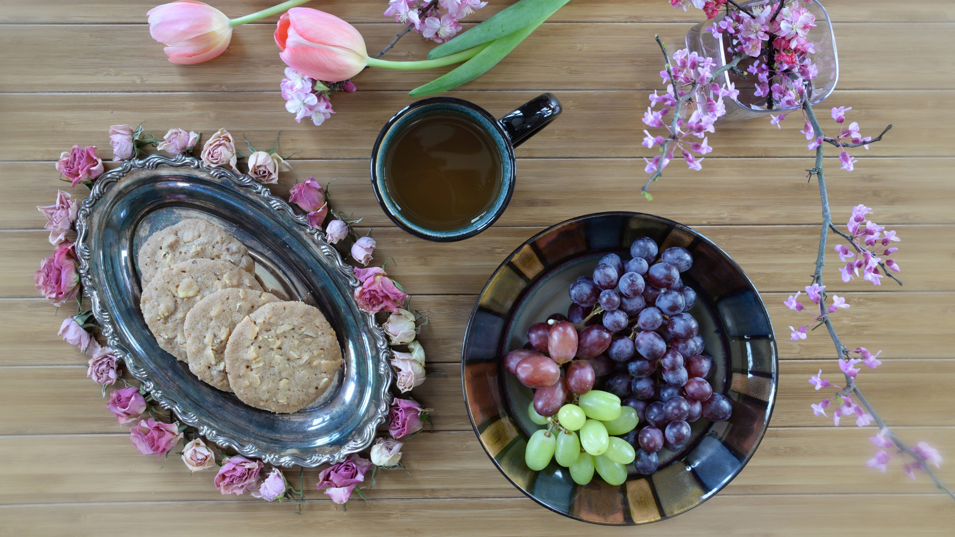 Still life with cookies, grapes, tea, and flowers HD Wallpaper