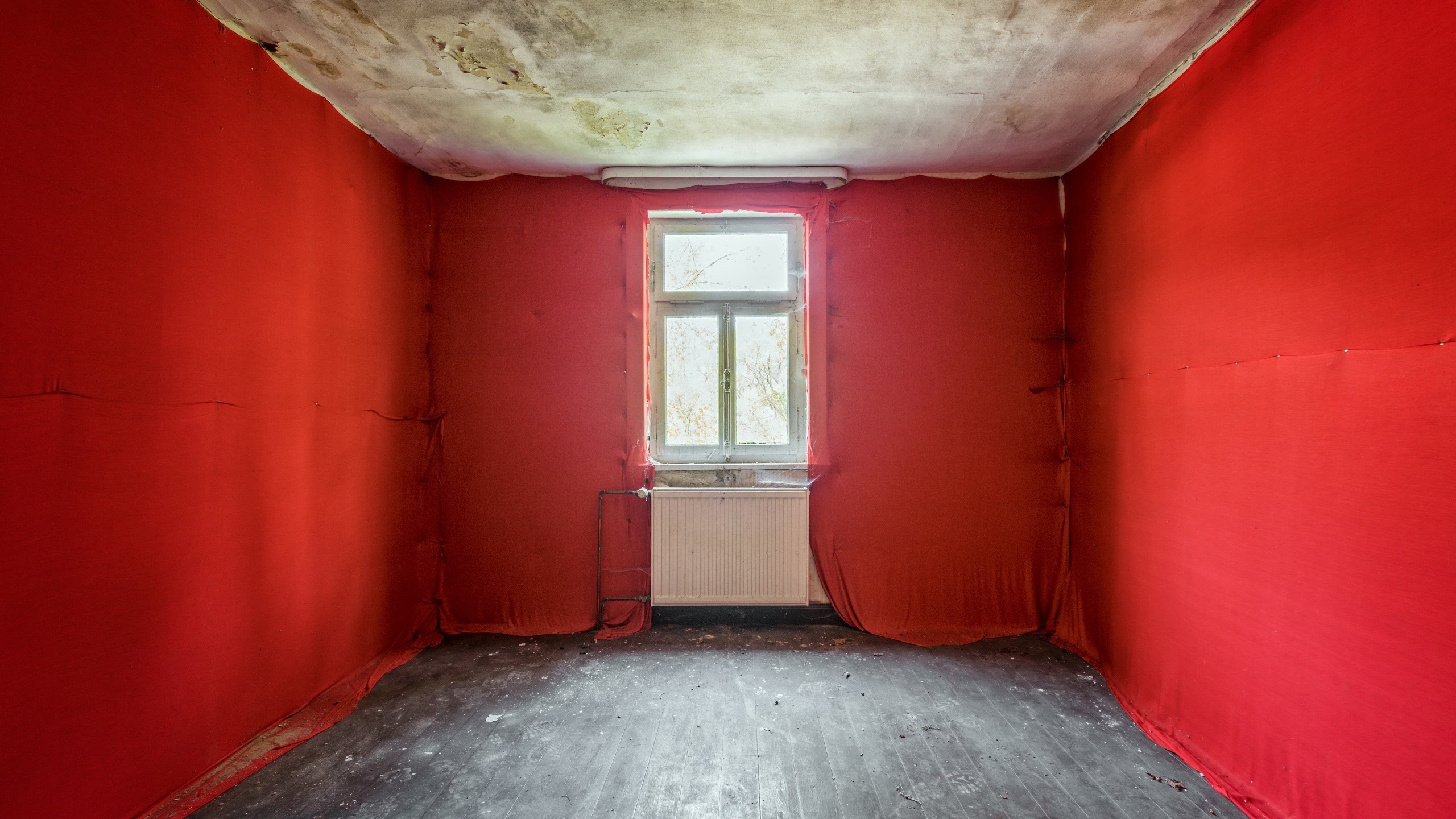 Empty room with red walls, window, and radiator HD Wallpaper